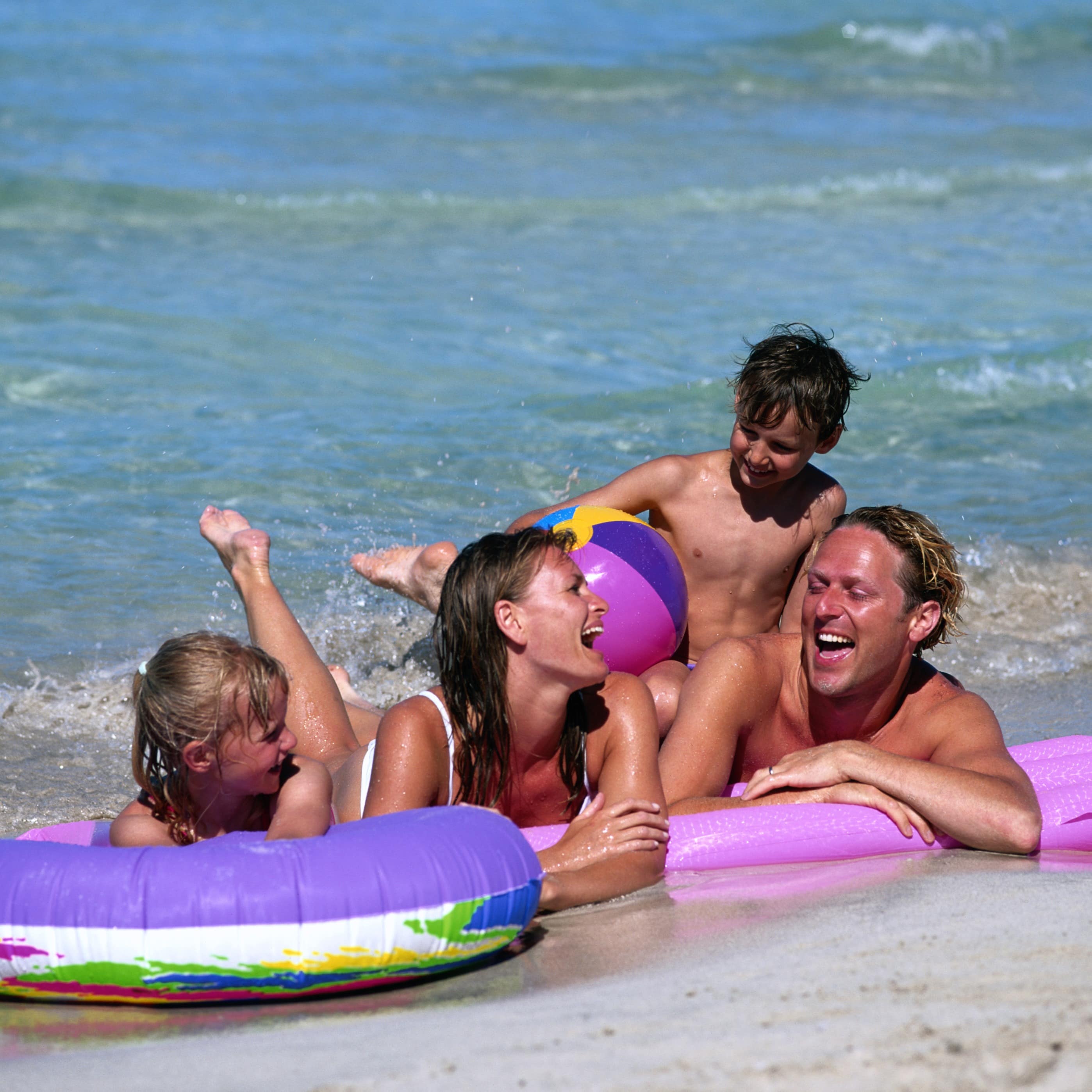 Familie hygger sig på stranden
