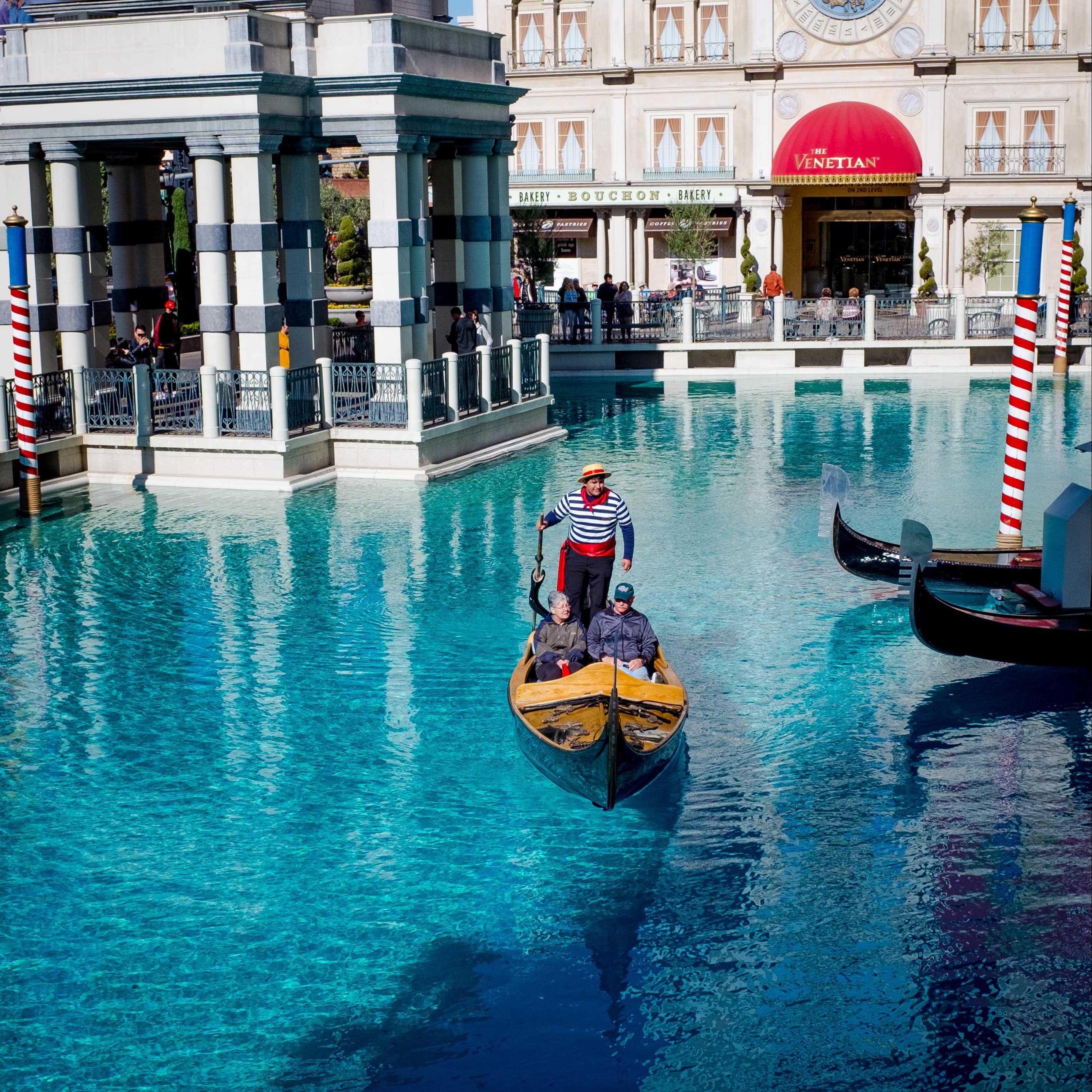 Couple taking a gondola ride in front of the Venentian Resort and Hotel