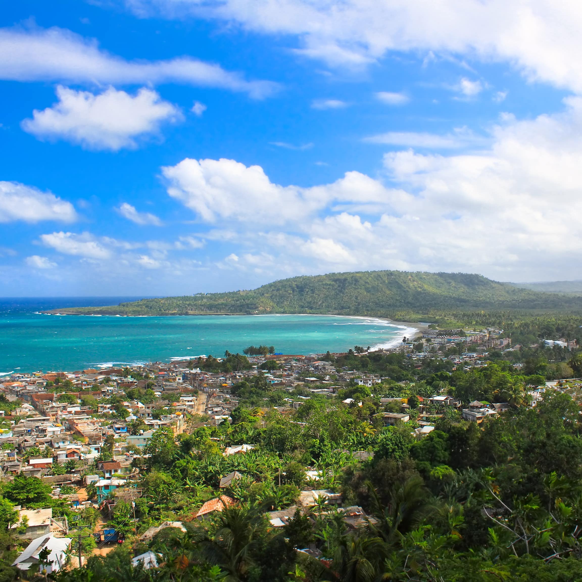 Panoramic view of Baracoa, Cuba with its neighbourhoods among lush green trees and turquoise waters