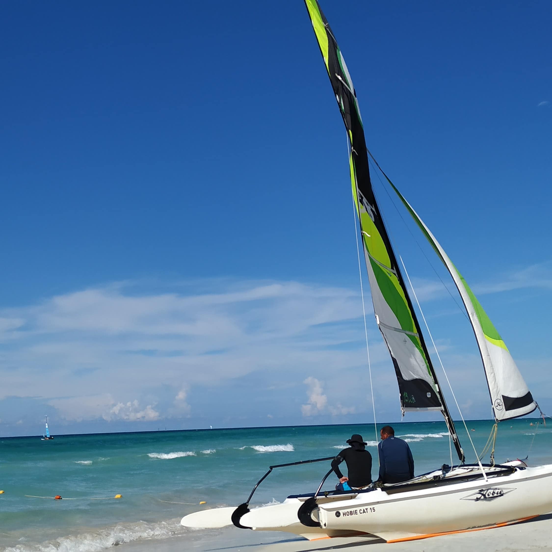 People sitting on a white boat on the seashore