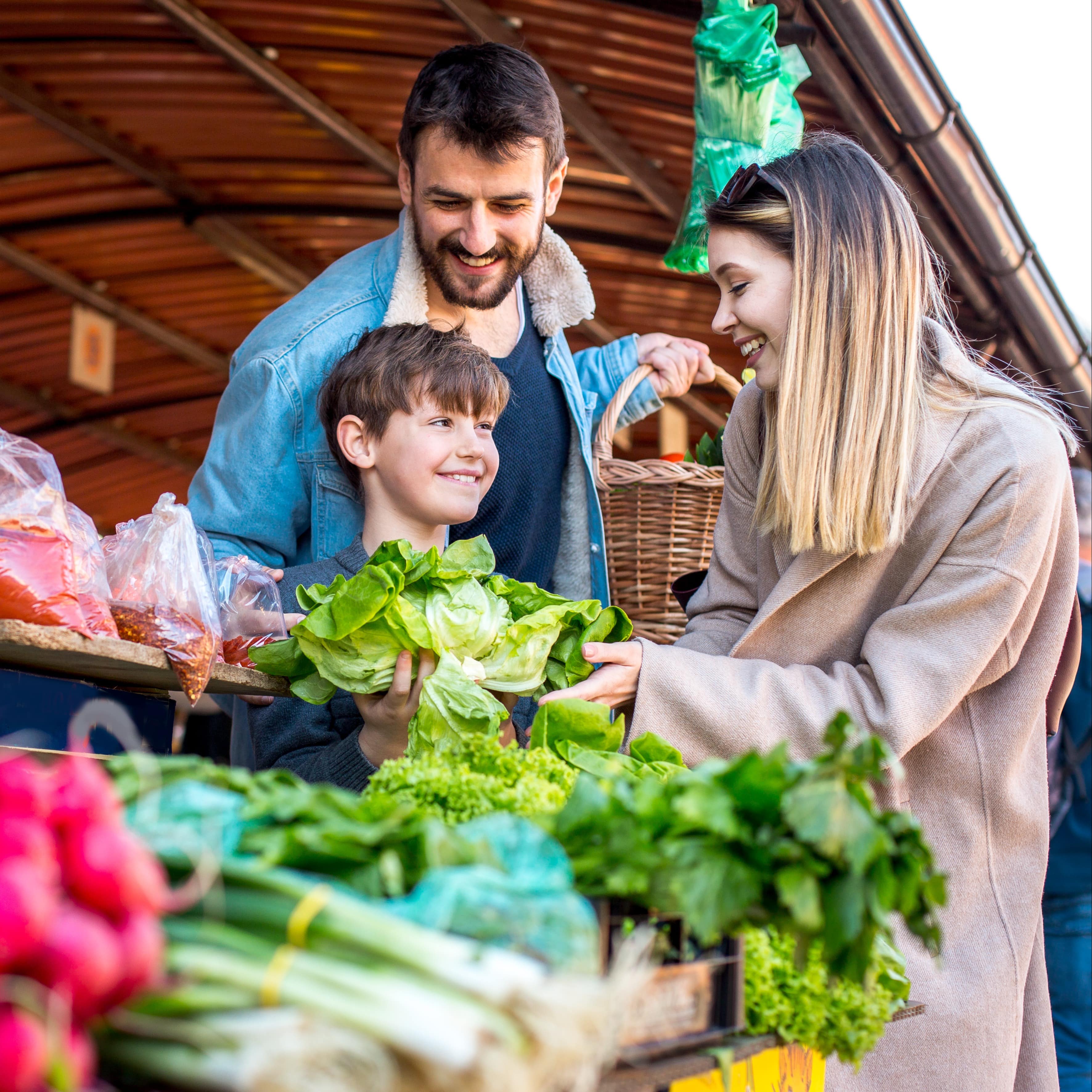 Family purchasing fresh produce at a farmers market