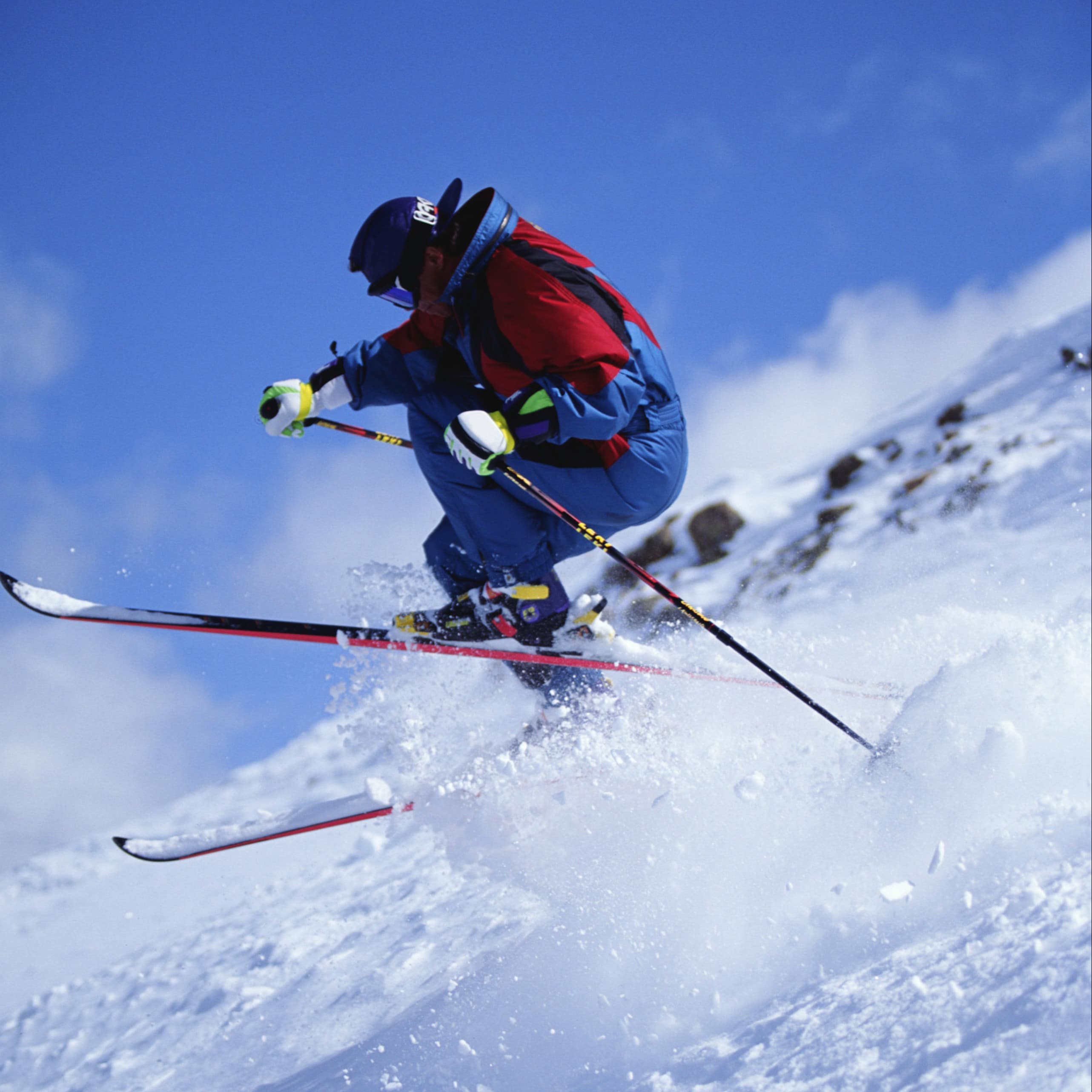 Man speeding down a slope on skis