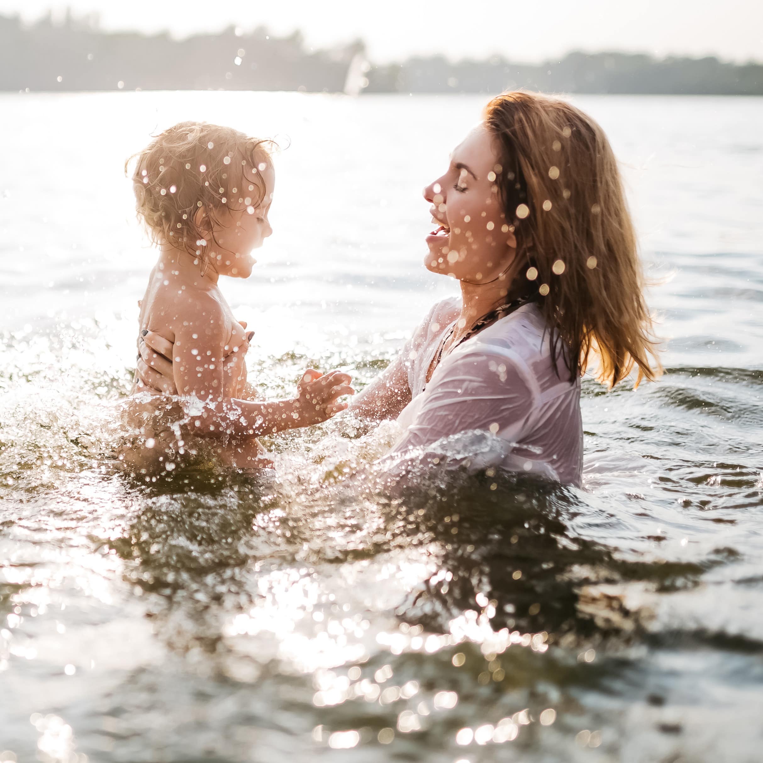 Mom and child playing in the lake