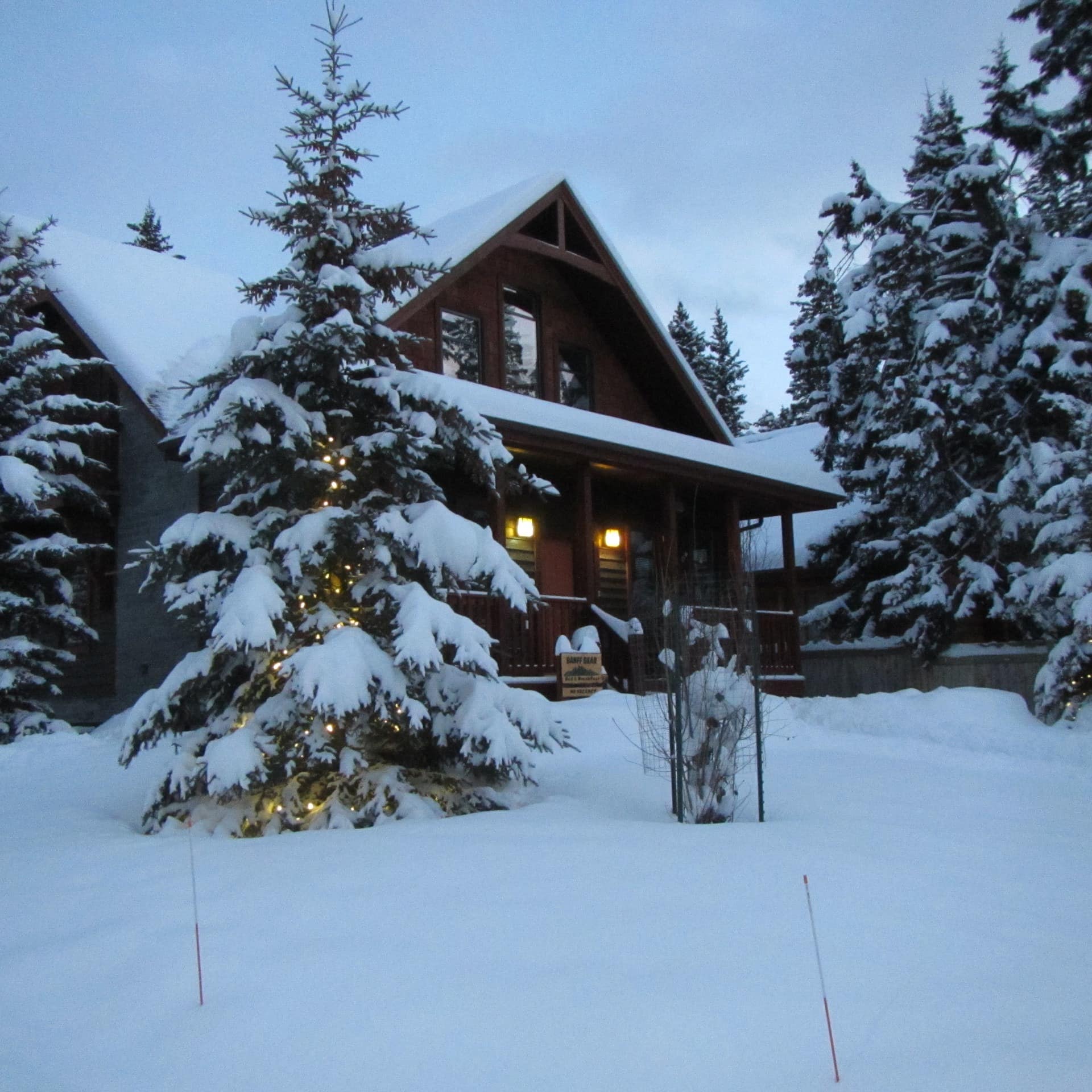 European-style, snow-covered chalet with views of Mount Norquay