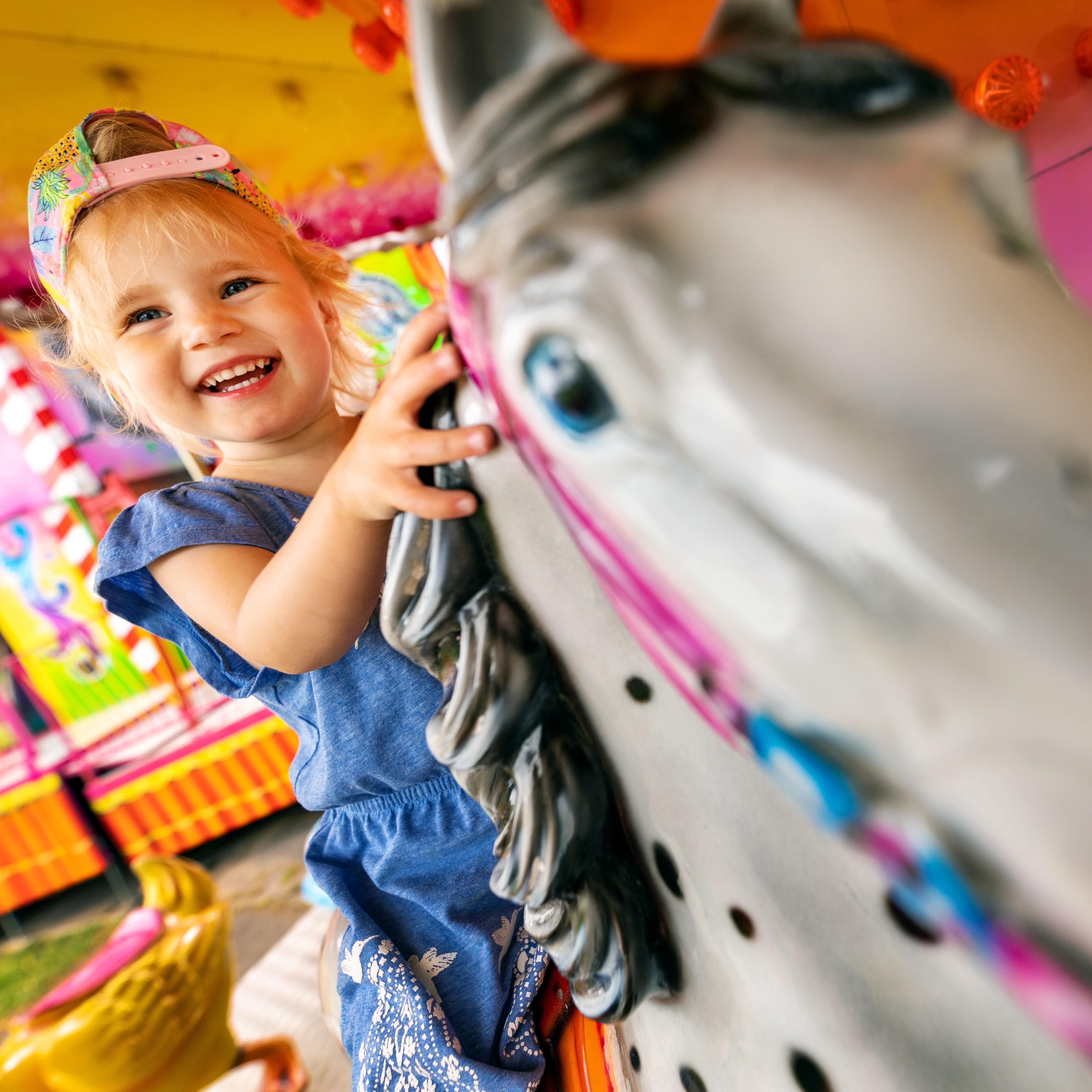 Young child riding on carousel