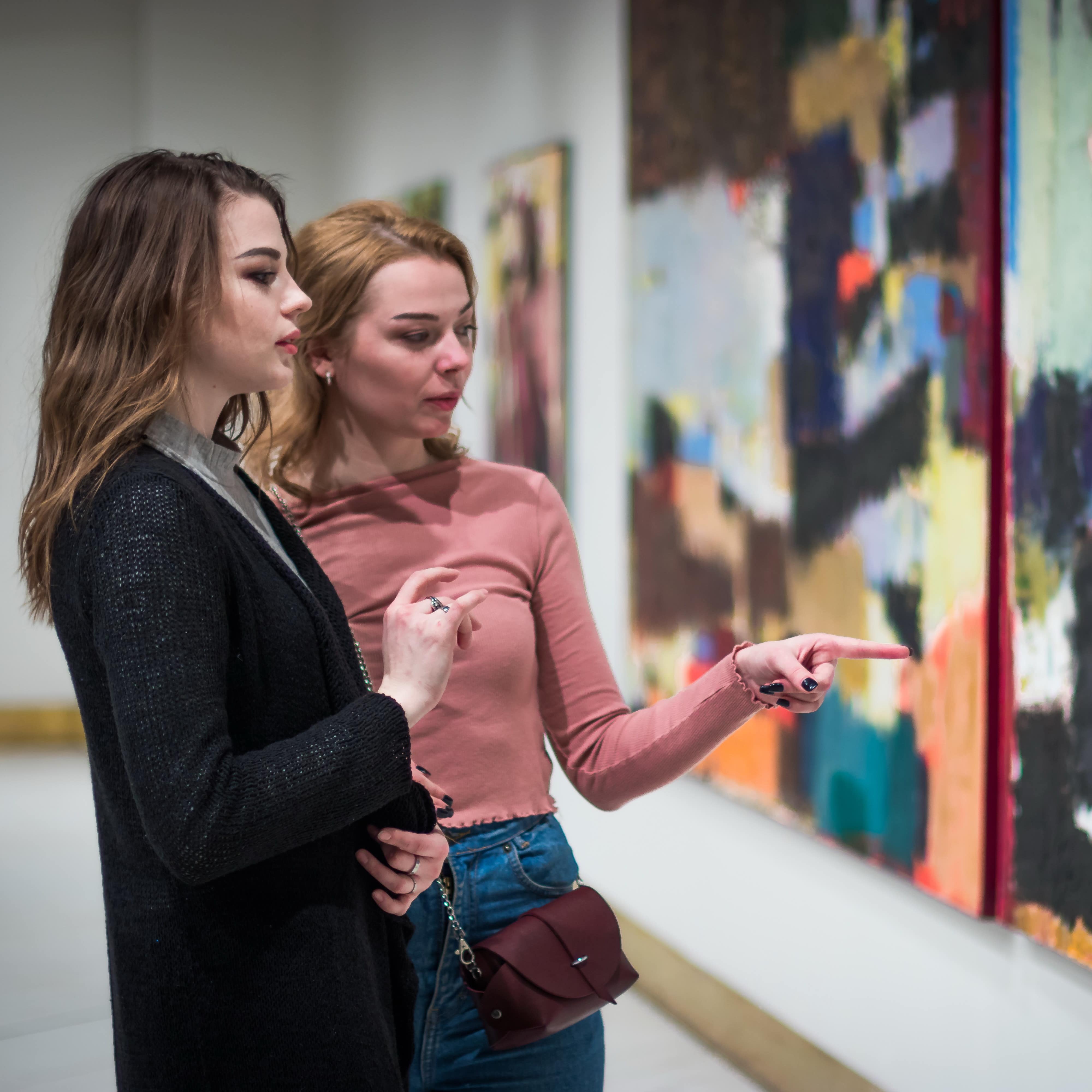 Two girls discussing art exhibit