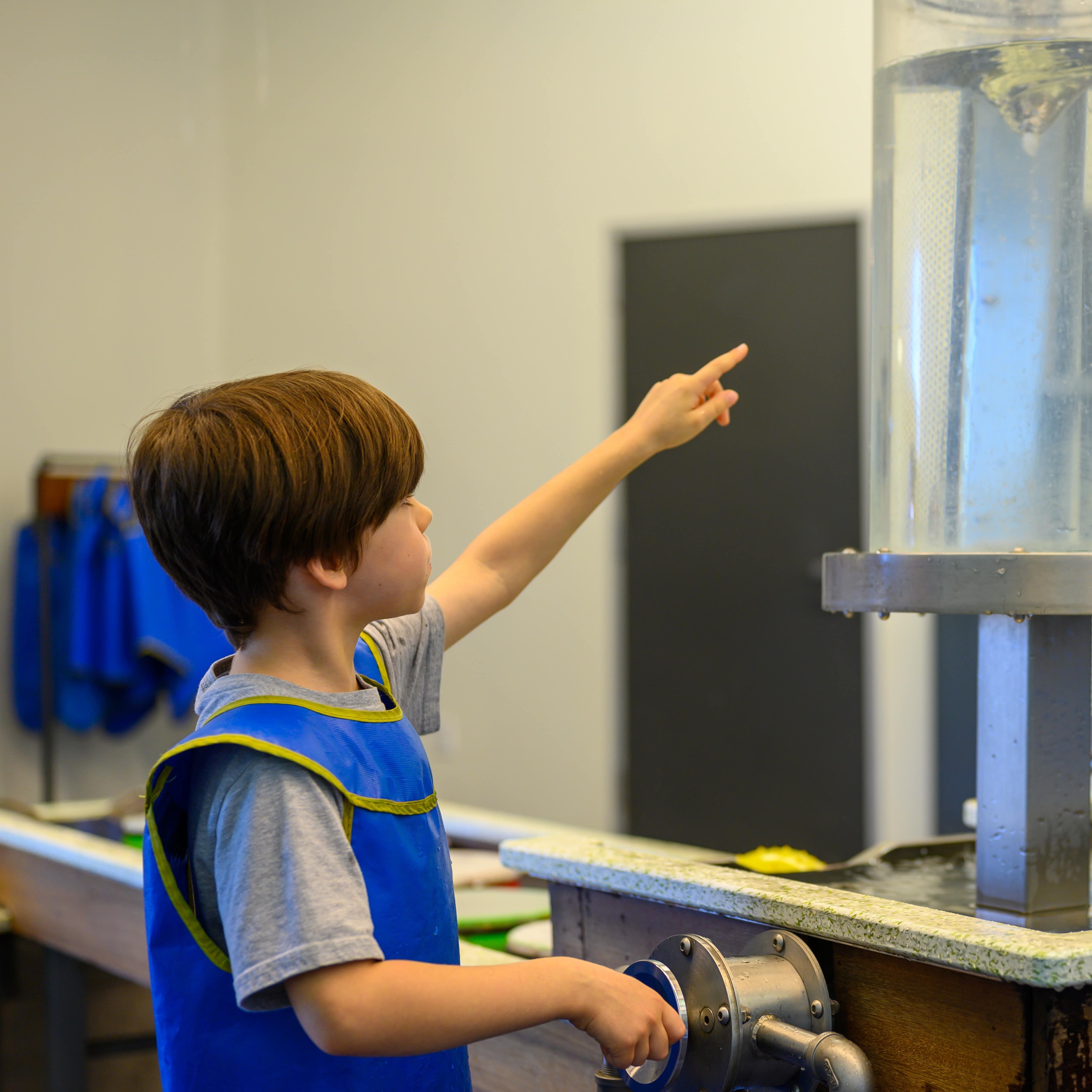 Little boy interacting with a science exhibit at a museum