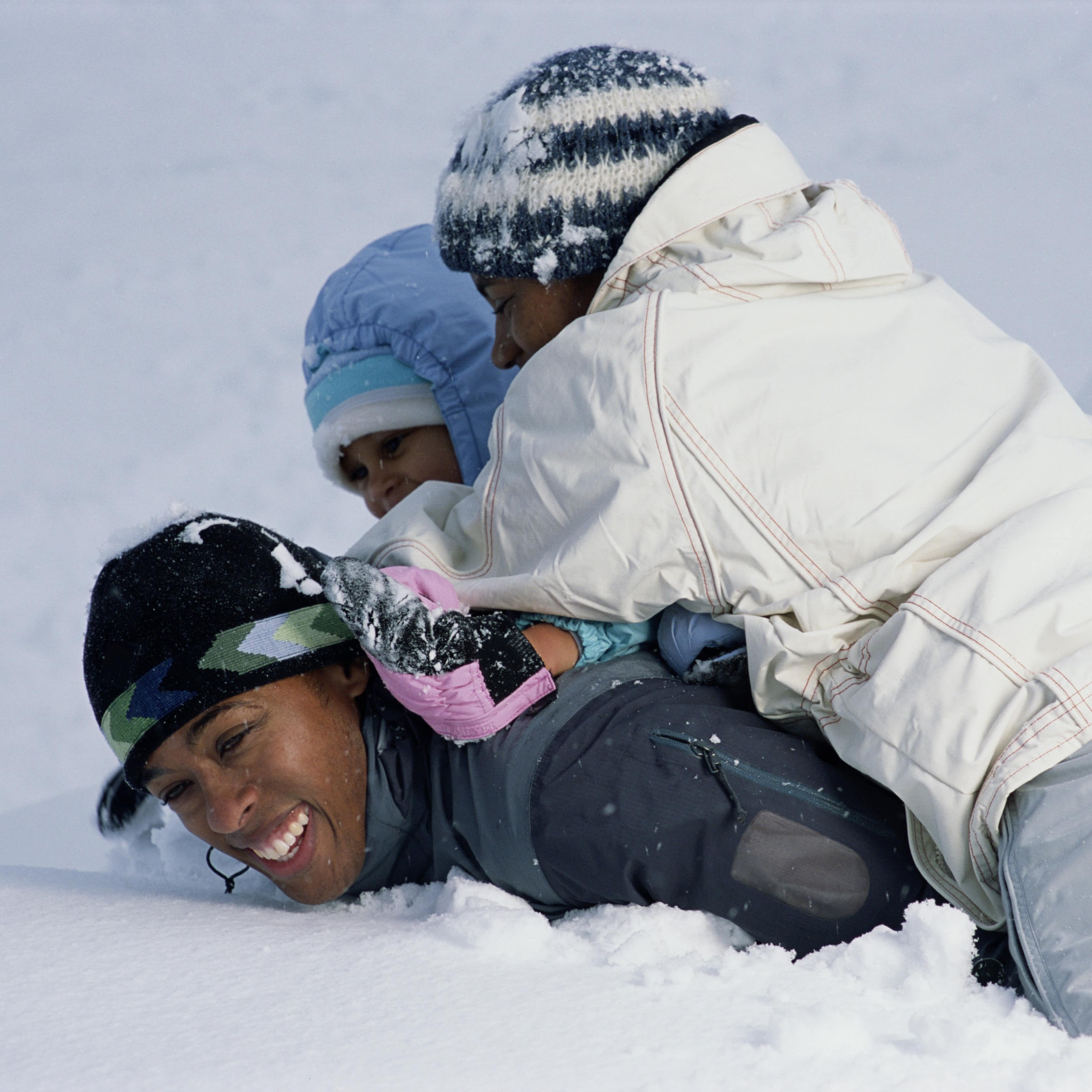 Family rough-housing in the snow