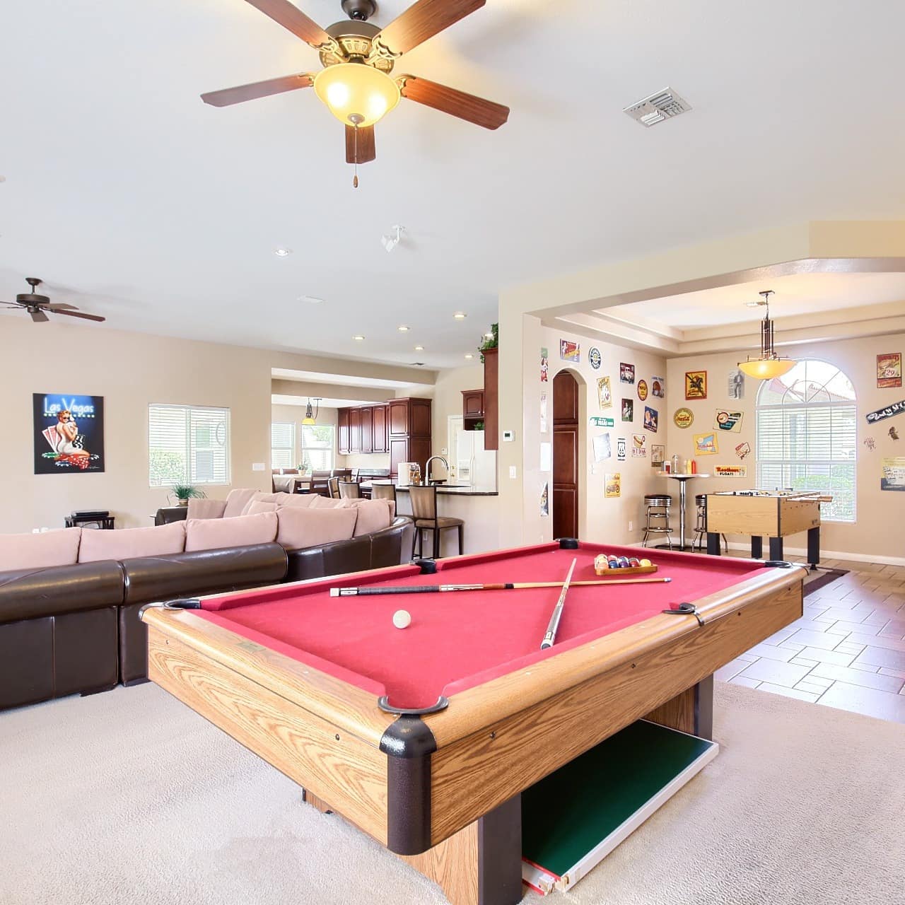 Game room of luxurious Las Vegas home with pool table, foosball, leather sectional and flat-screen TV