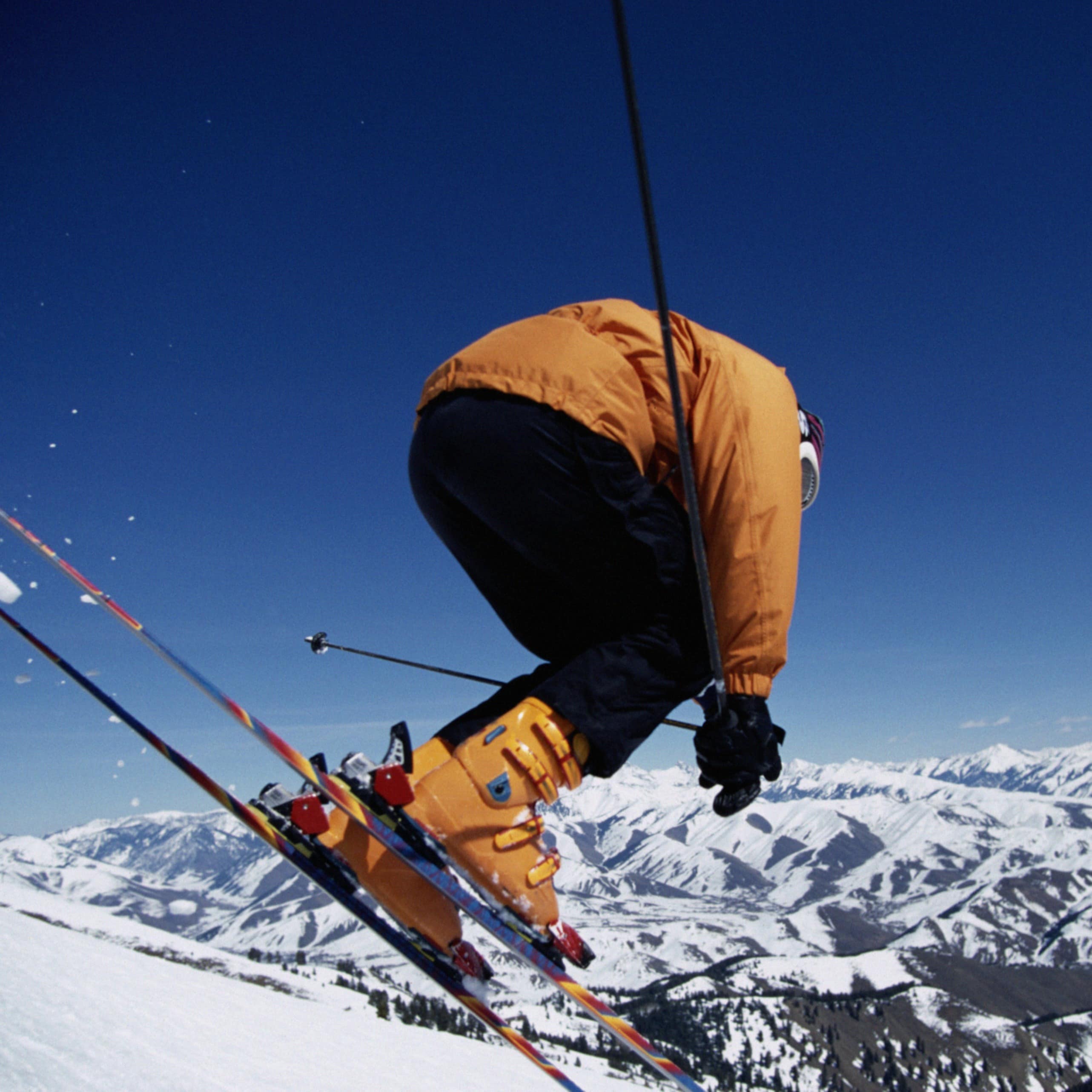 Skier landing on snowy terrain from a jump