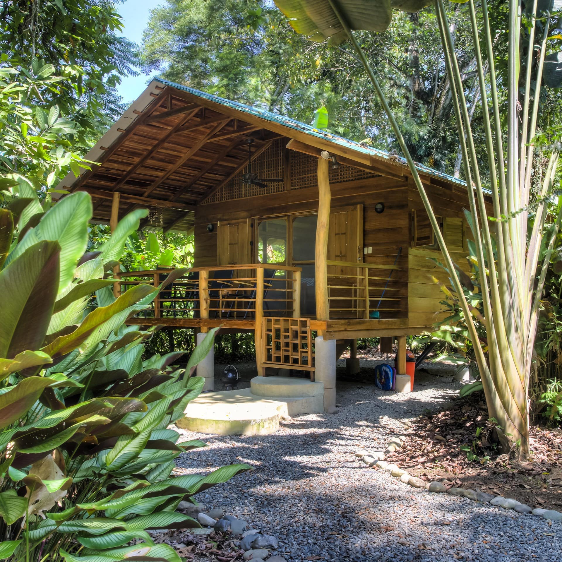 An eco-friendly jungle lodge with a small porch in Costa Rica