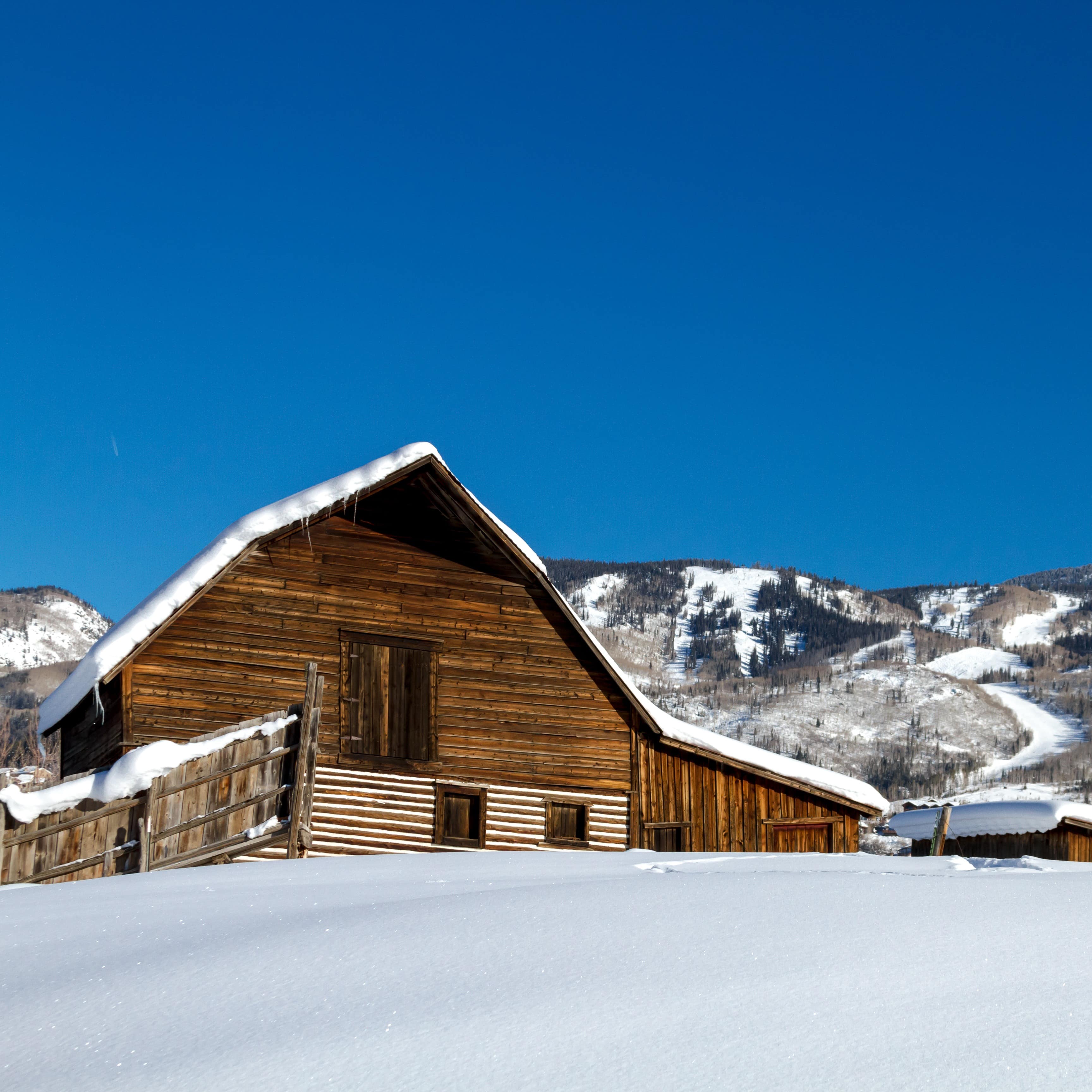 Historic barn with open view of snowy hills in Steamboat Springs