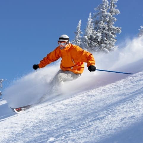 Male skier going down an advanced ski slope