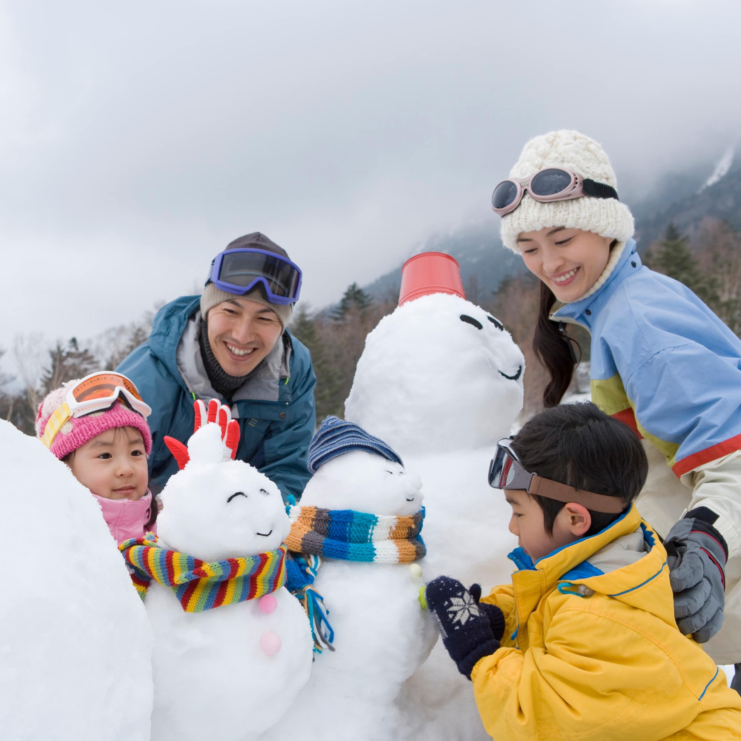 Family building a family of snowmen