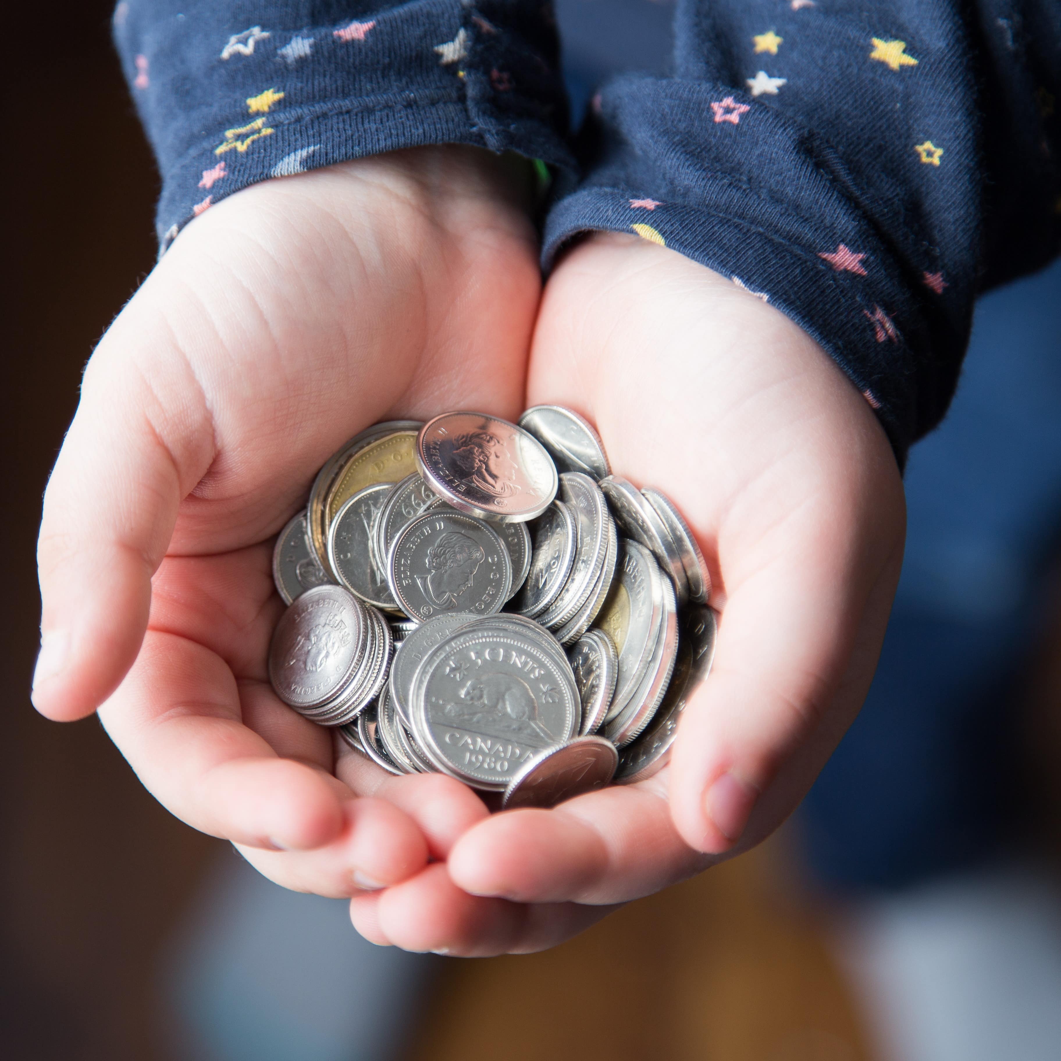 Hands holding coins