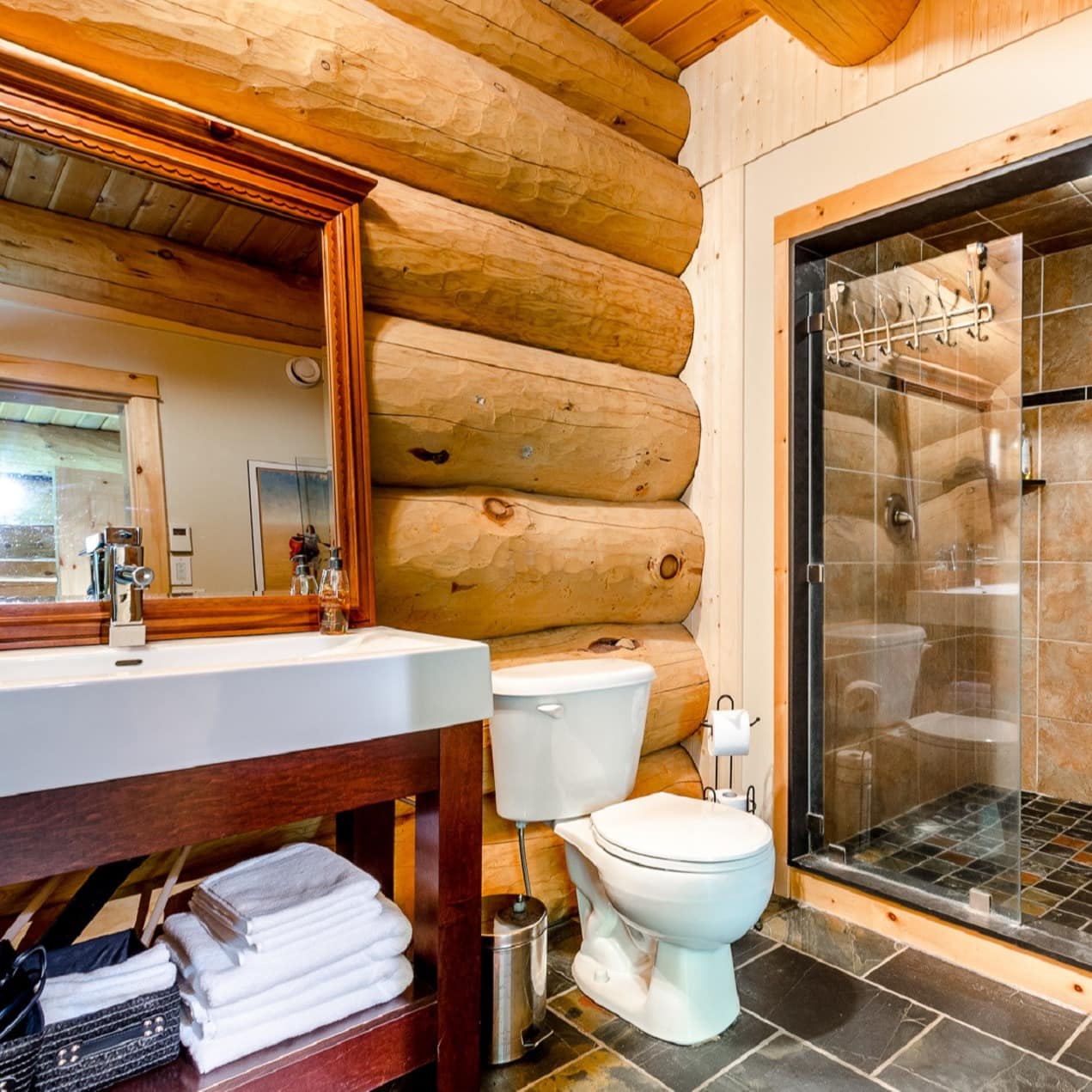 Custom designed log bathroom with two person shower and heated slate floor