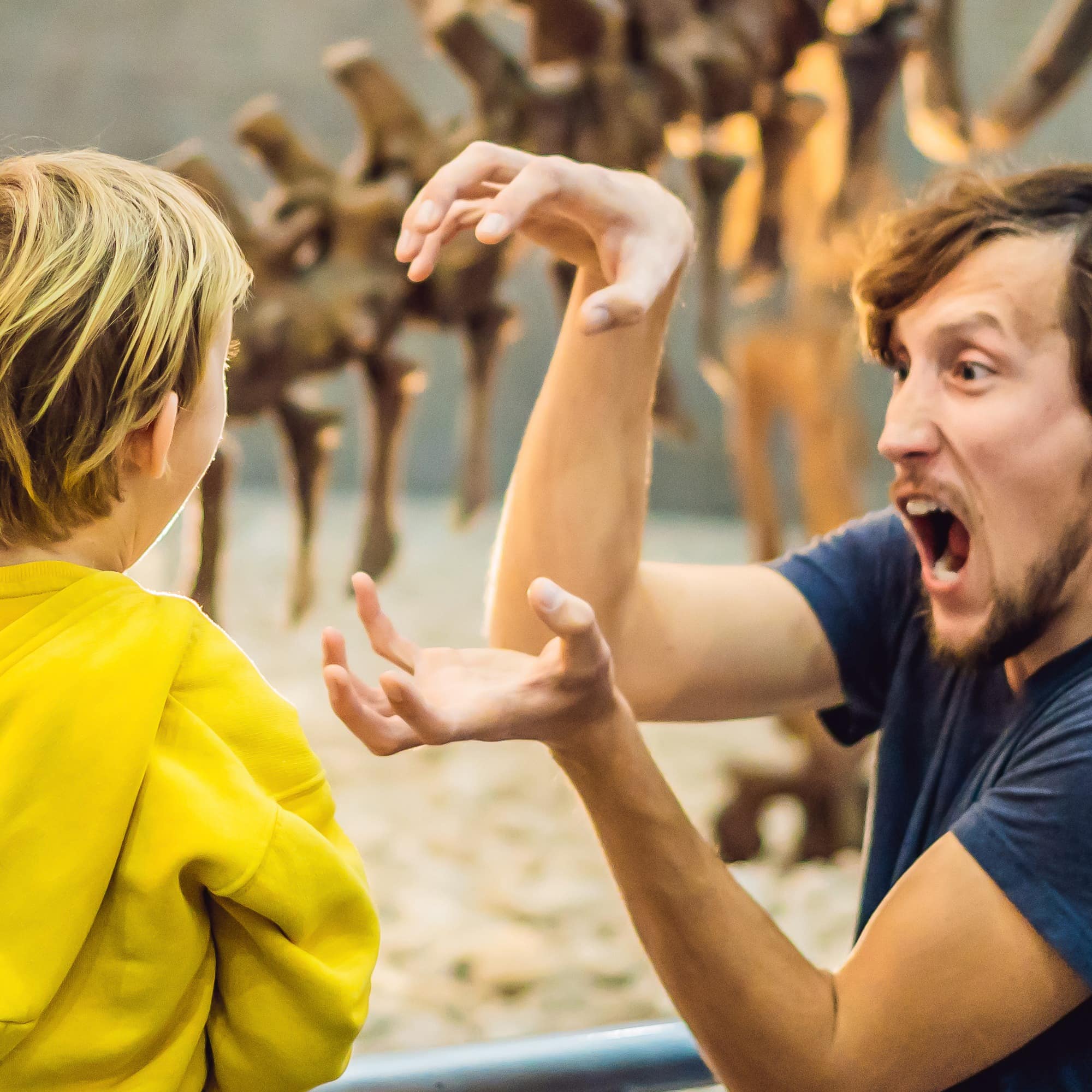 Dad and son looking at dinosaur skeleton
