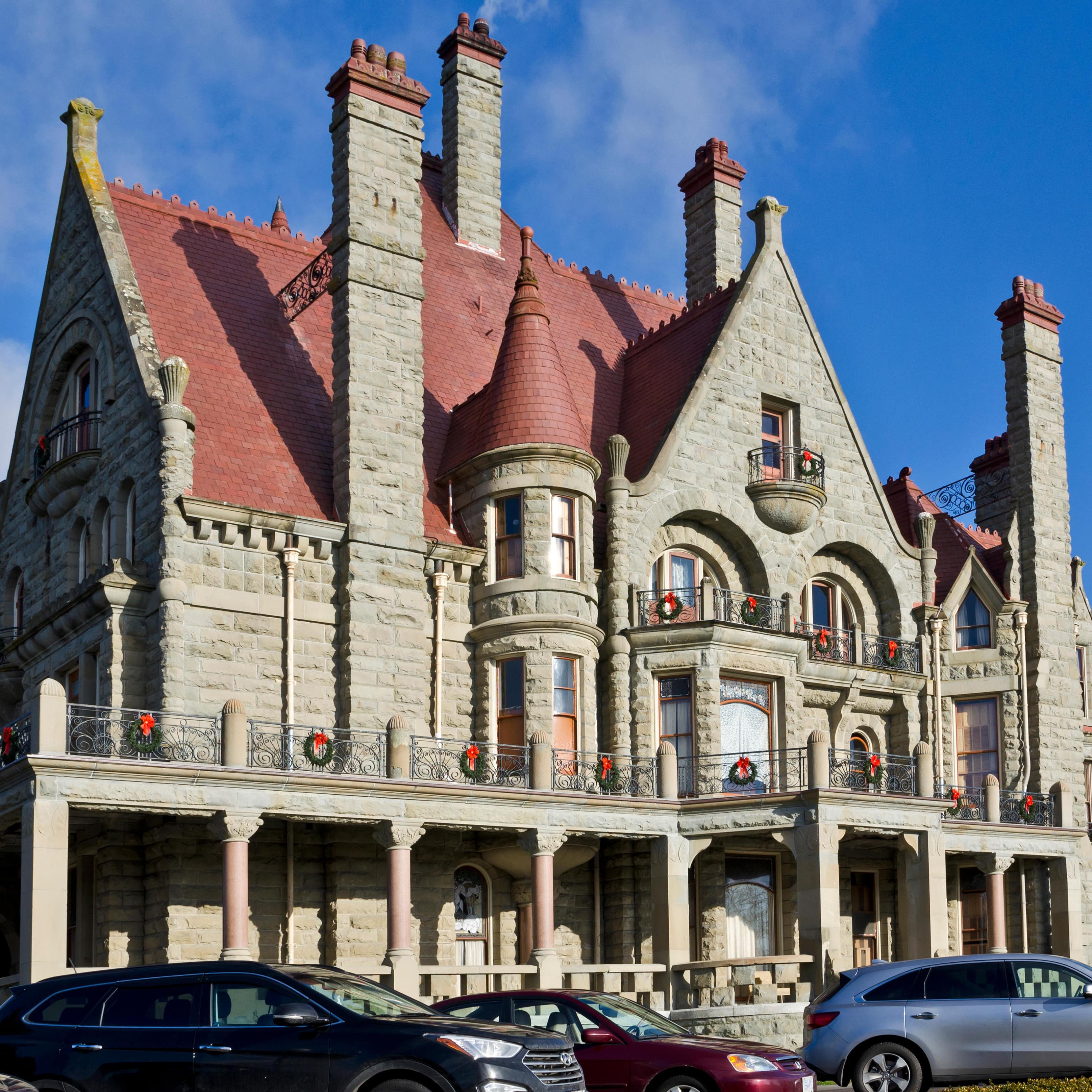 Craigdarroch Castle with cars in front
