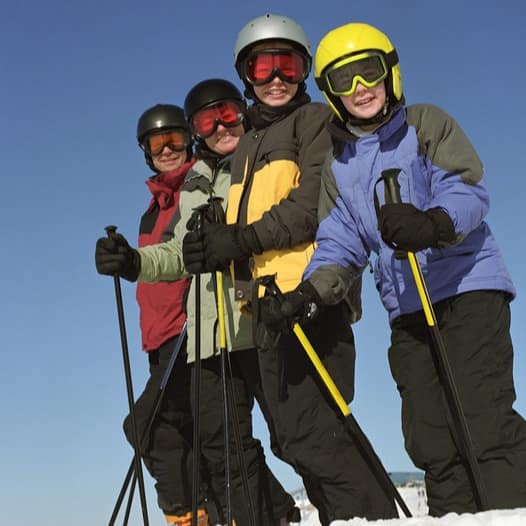 Family posing for a picture while skiing