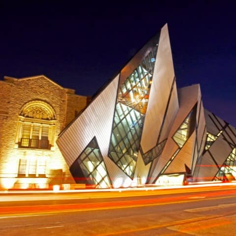 A night shot of a Museum with a cyrstal extension.
