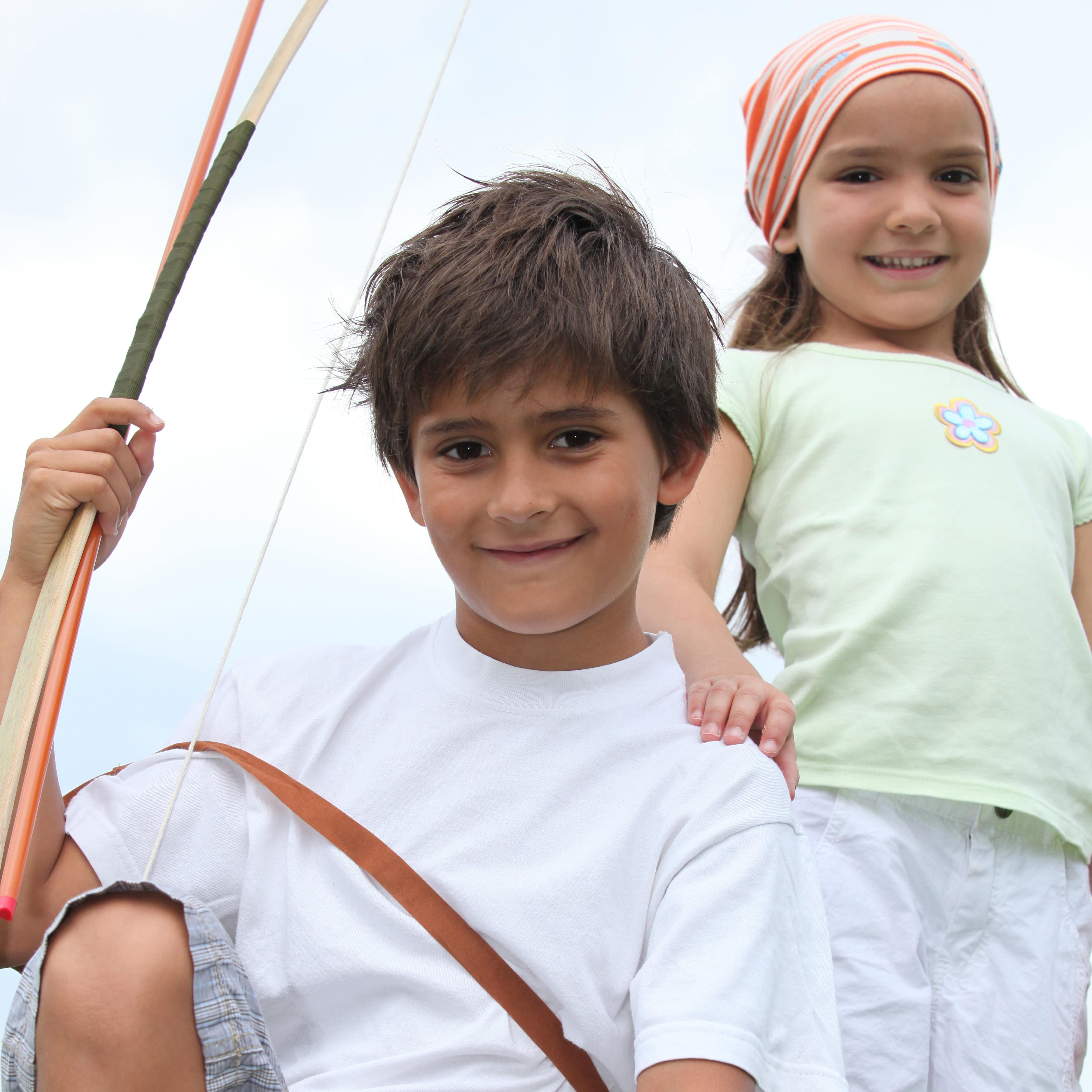 Close up of children holding bow and arrow