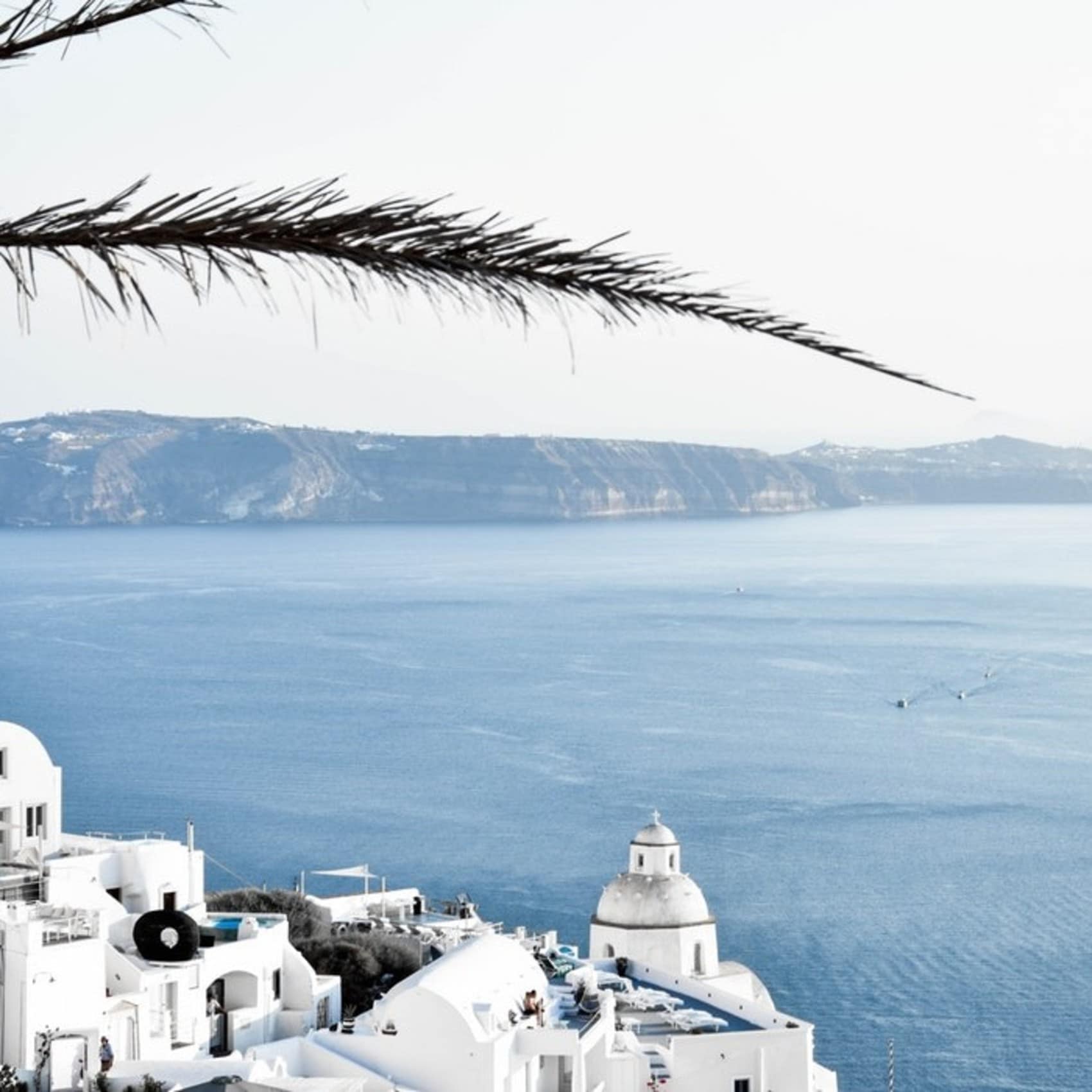 Villa rentals stud the cliffs of Santorini in Greece
