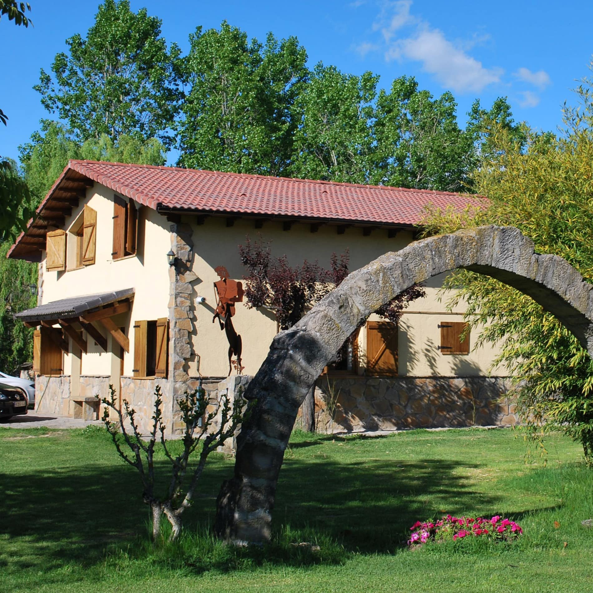 Casa rural con mucho encanto con un bonito arco de piedra en el jardín