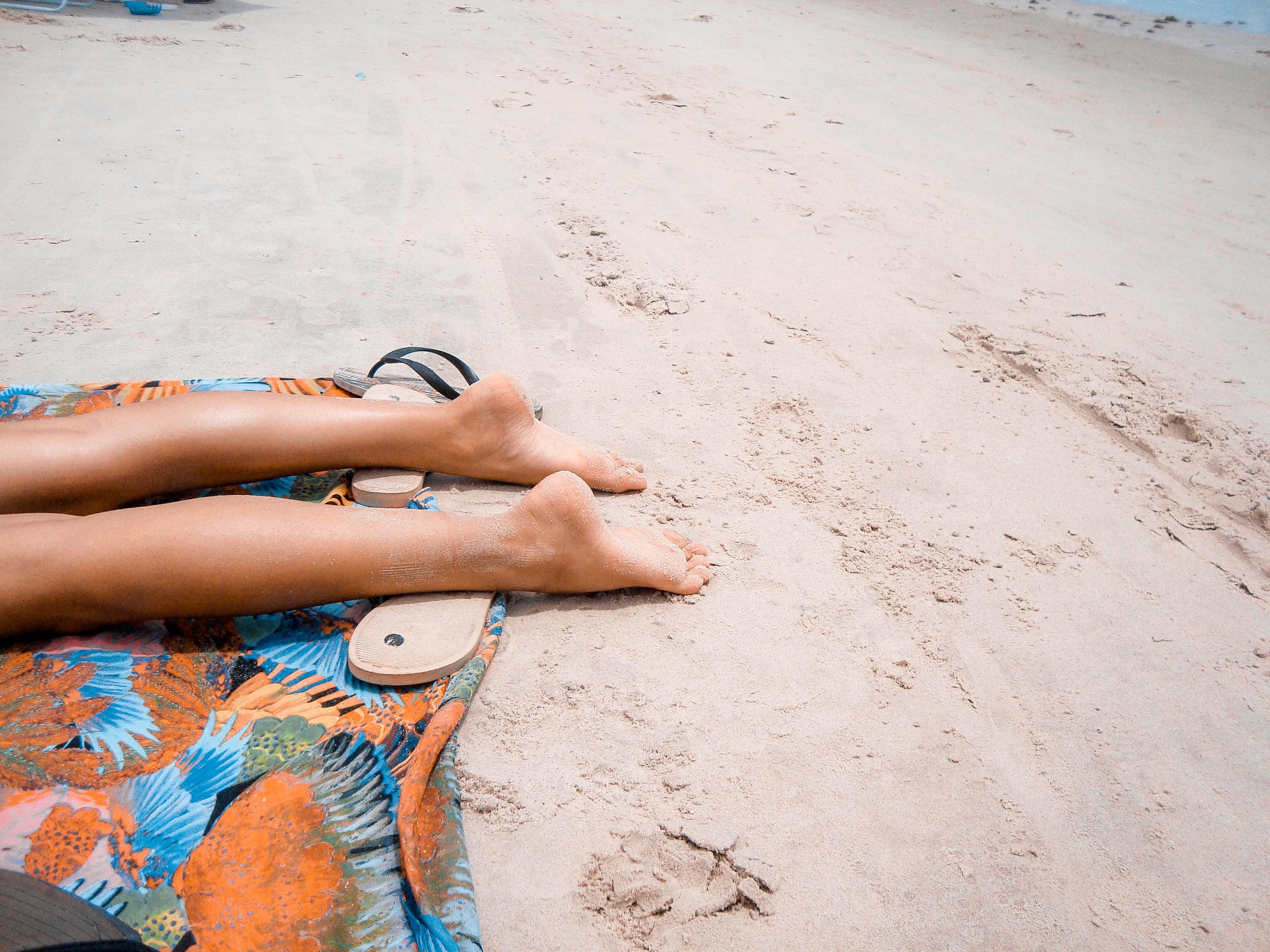 Stock image - Pitimbu Brazil - person sunbathing on beach holiday - Photo by Matheus Vinicius