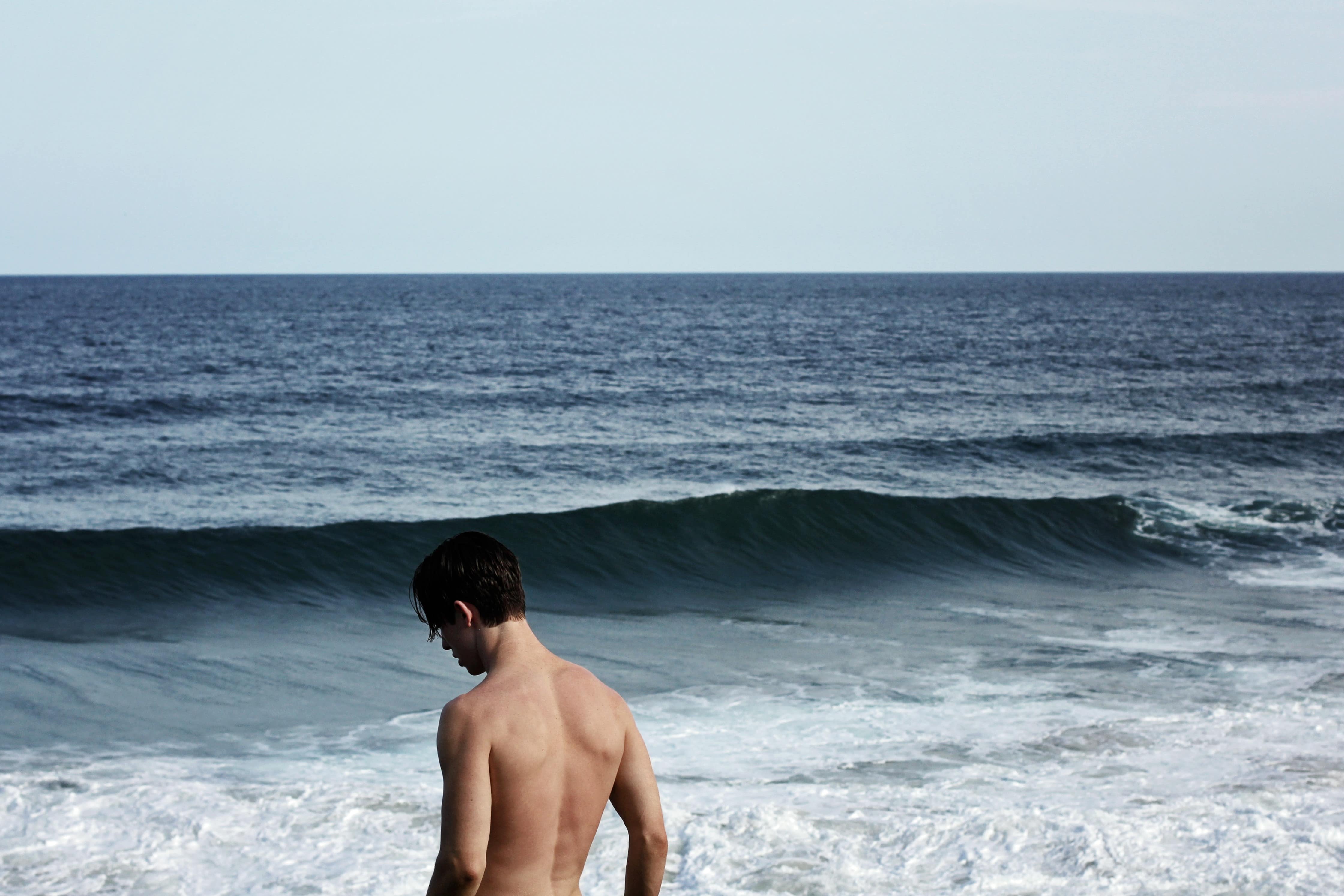 Stock image - Topless man on a beach in Fingal Head Australia - beach holiday vacation nudist - Photo by Christopher Campbell
