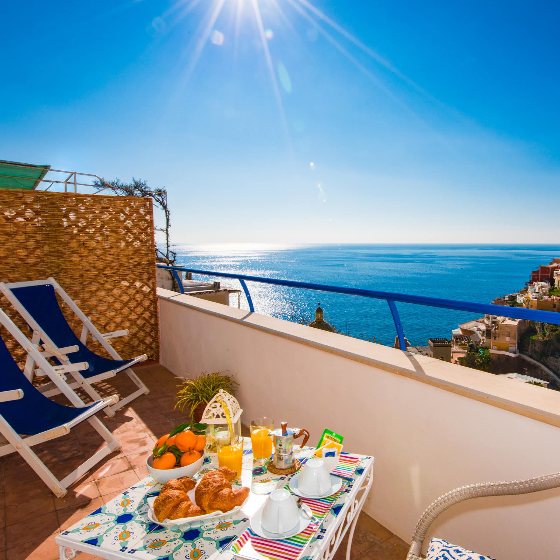 A typical balcony along the Amalfi coast, with a sumptuous Mediterranean breakfast and sea views