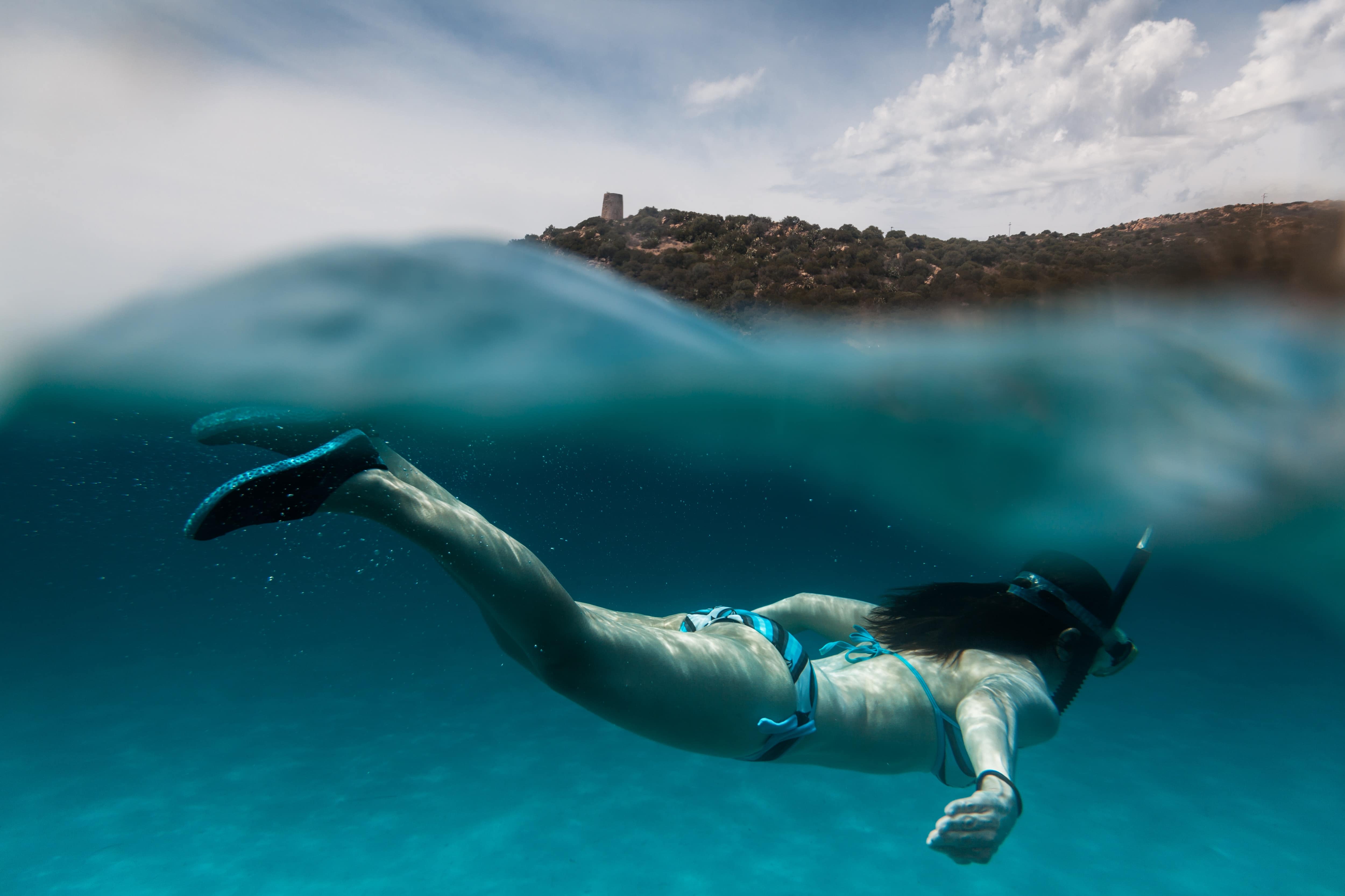 Stock image - Woman snorkelling swimming under the sea water - Sardinia, Italy - Photo by Alessandro Vallainc on Unsplash