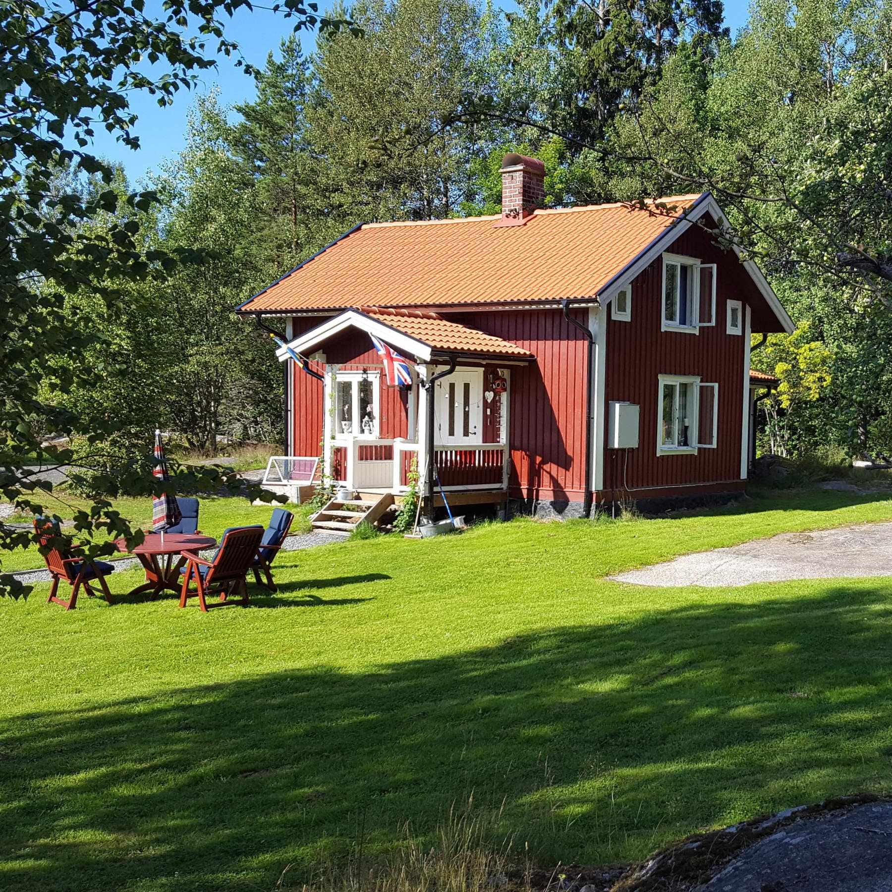 Rött fritidshus med uteplats