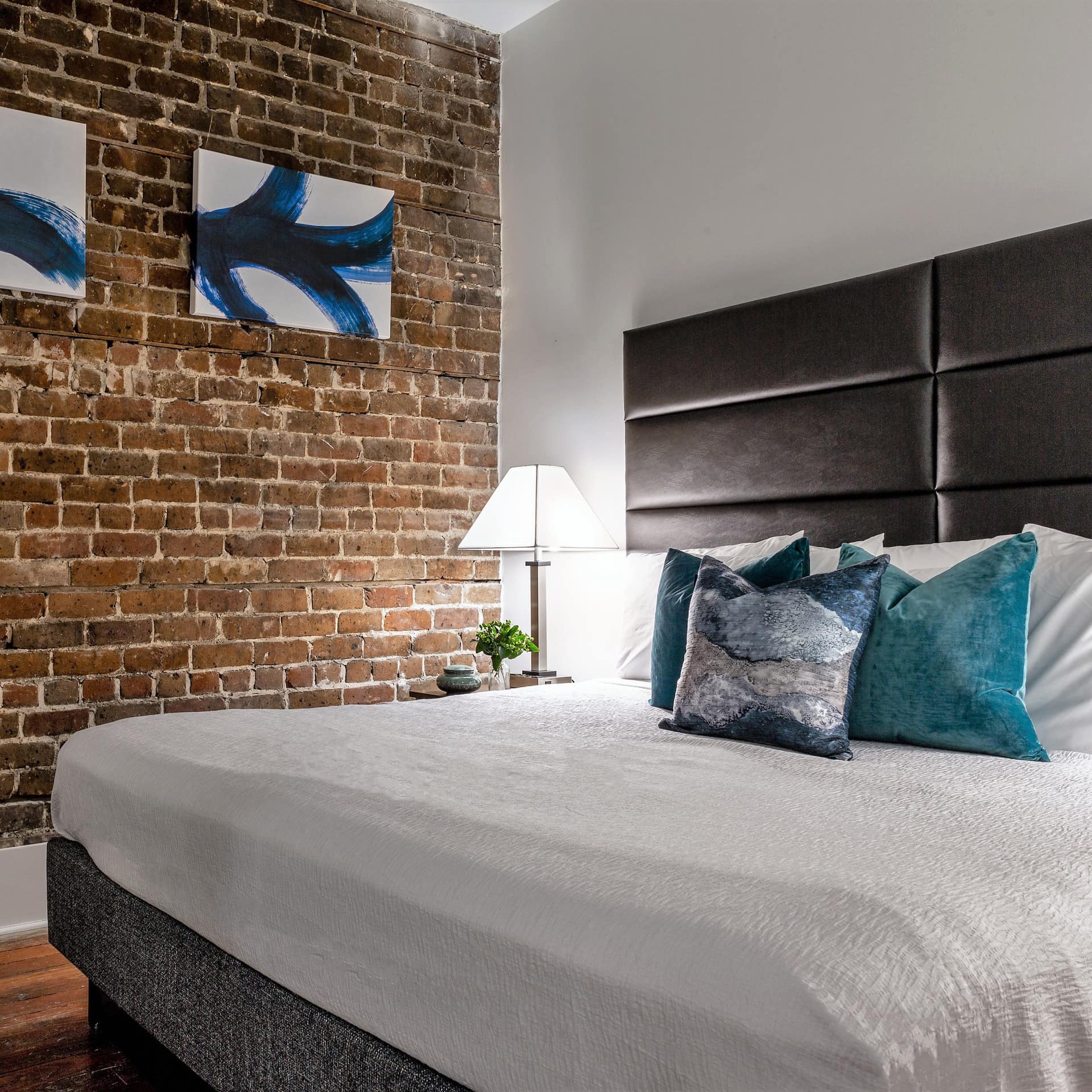 Bedroom with an exposed brick wall in a Savannah vacation rental