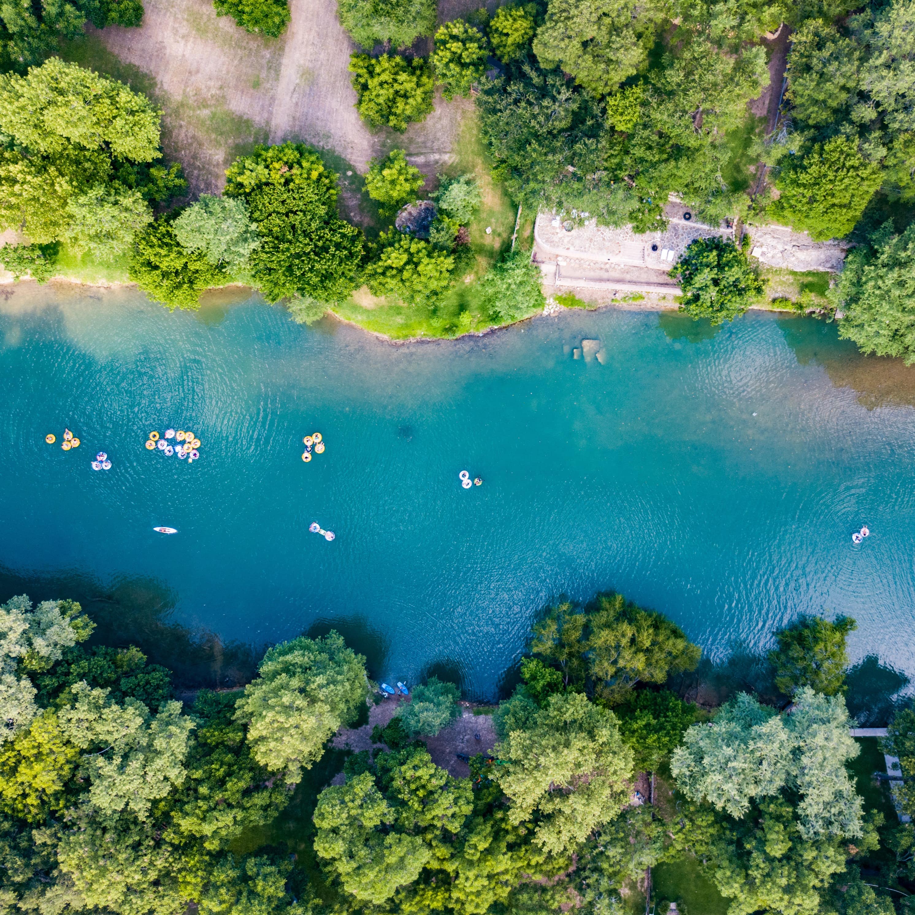 Aerial view of people tubing through New Braunfels, Texas