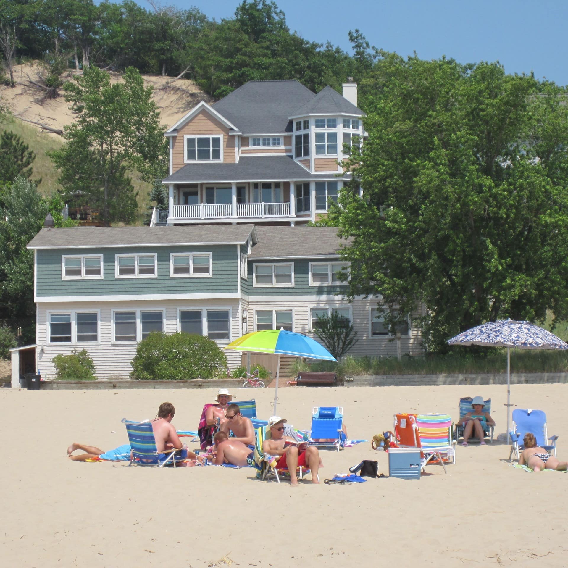 Vacationers relax near a beachfront vacation rental in Holland, Lake Michigan