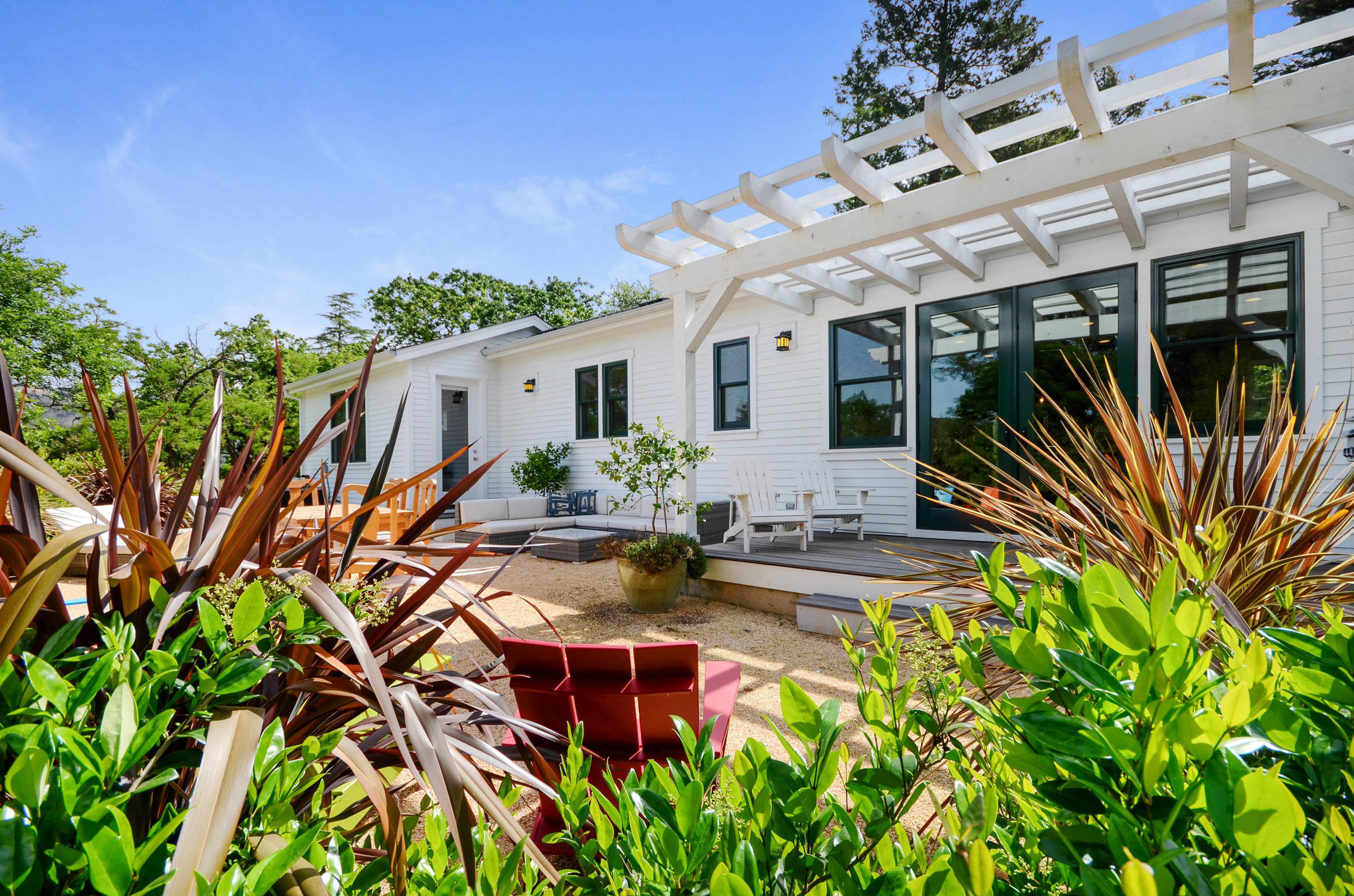 This 3-bedroom modern farmhouse features a wraparound front porch and hot tub for guests to enjoy
