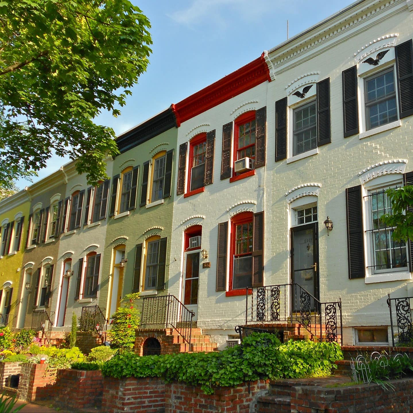 A row of stately Georgian townhouses in a leafy neighborhood