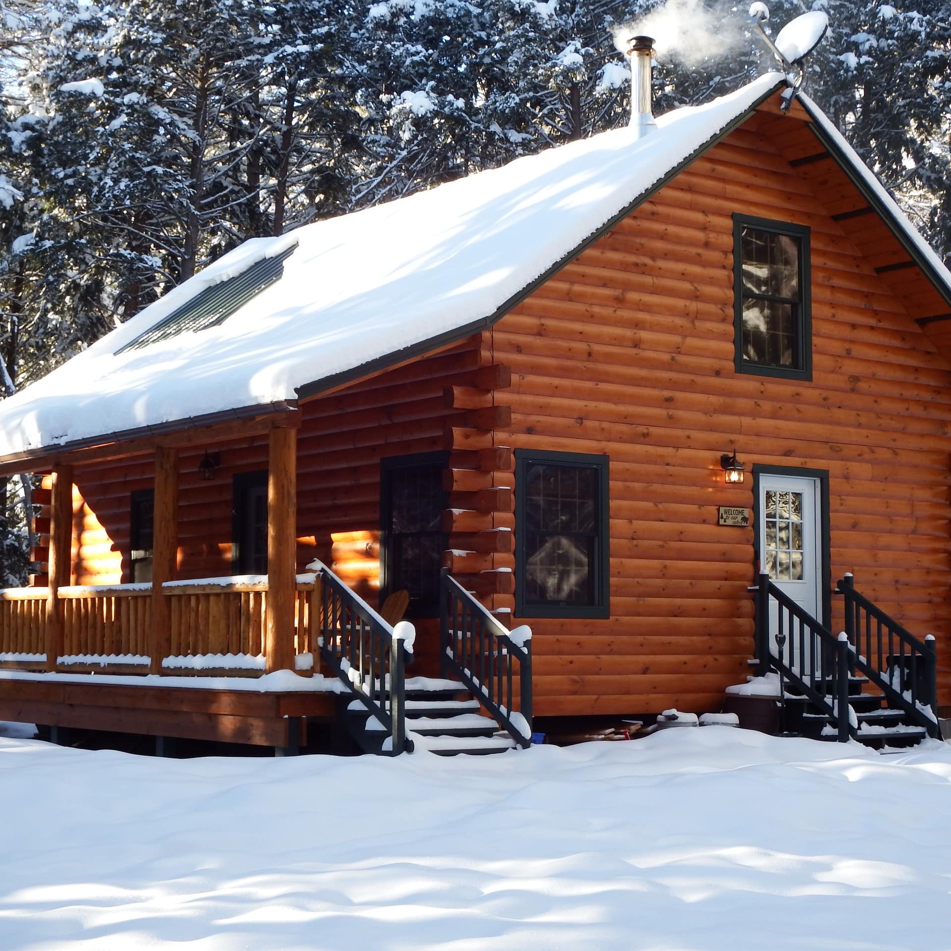 A cozy cabin in the woods covered with a fresh coat of snow