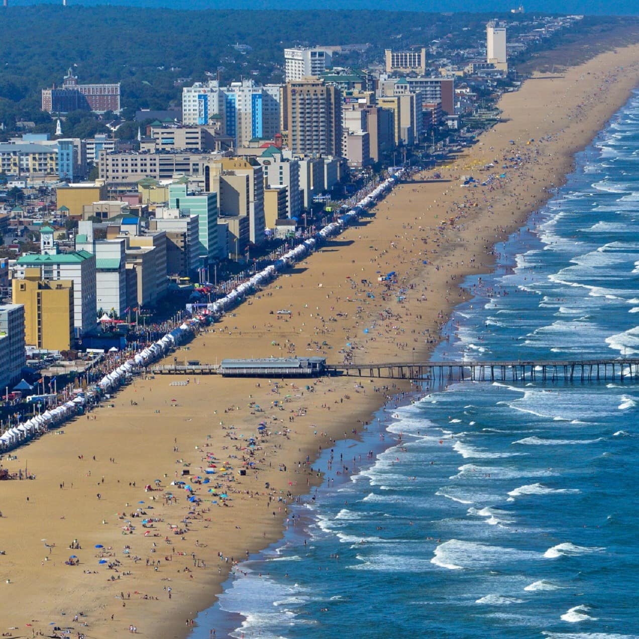 A shot of long Virginia Beach, complete with boardwalk, pier, and rolling Atlantic surf