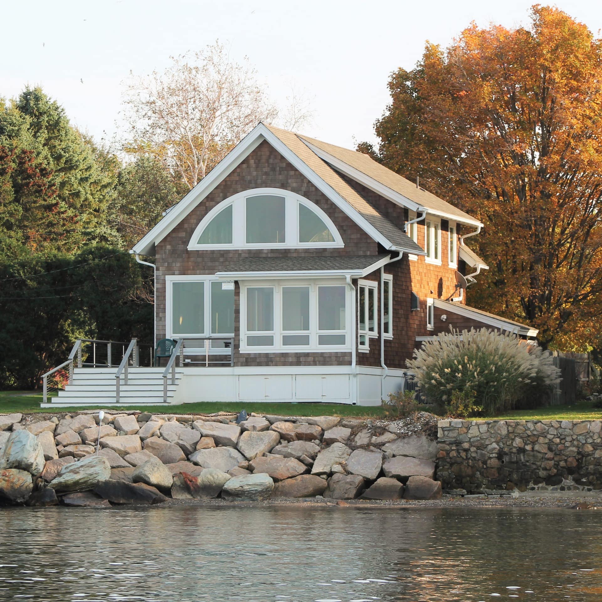 A handsome Rhode Island rental right by the water's edge with a garden and jetty