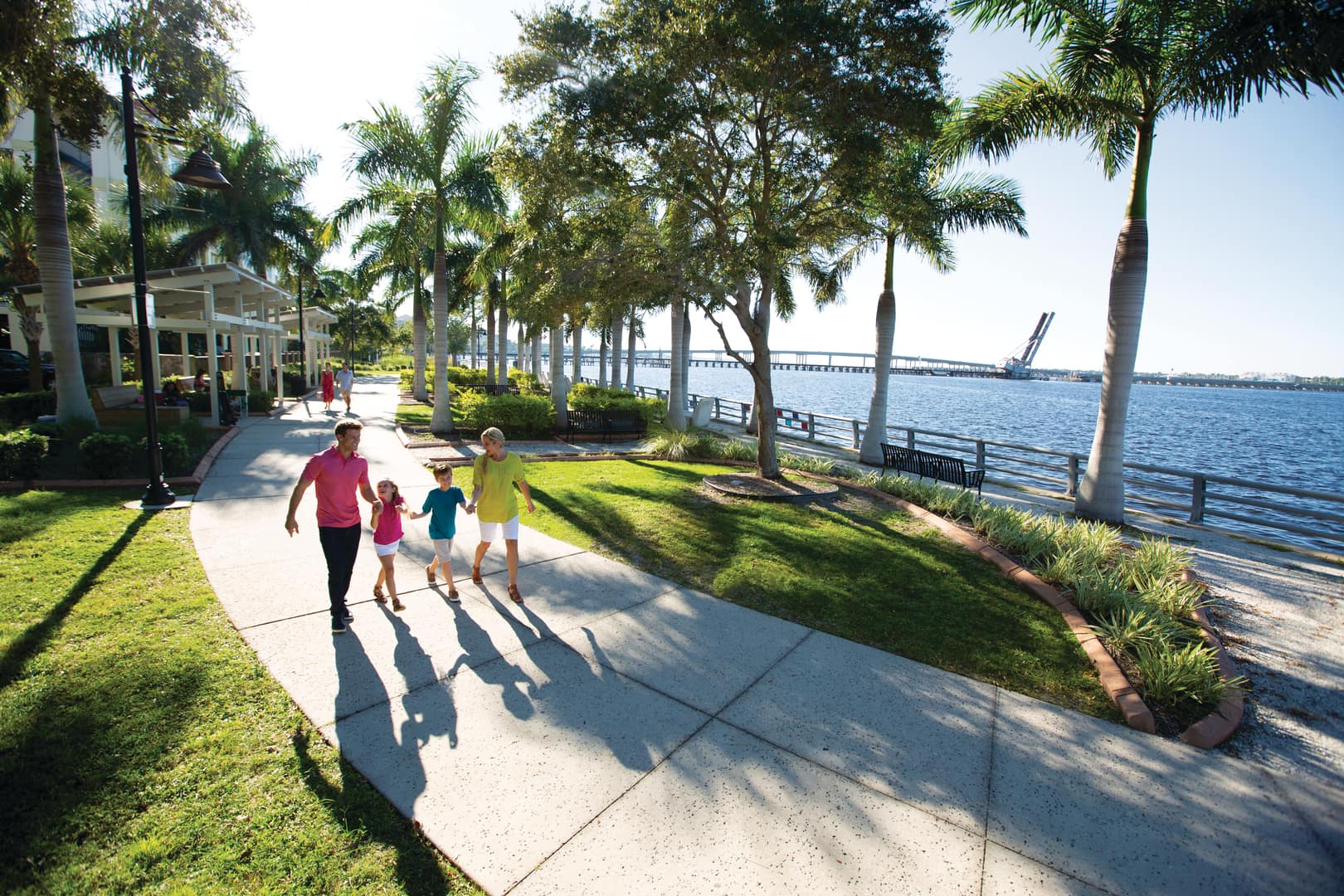 Family of four walking on the Bradenton Riverwalk