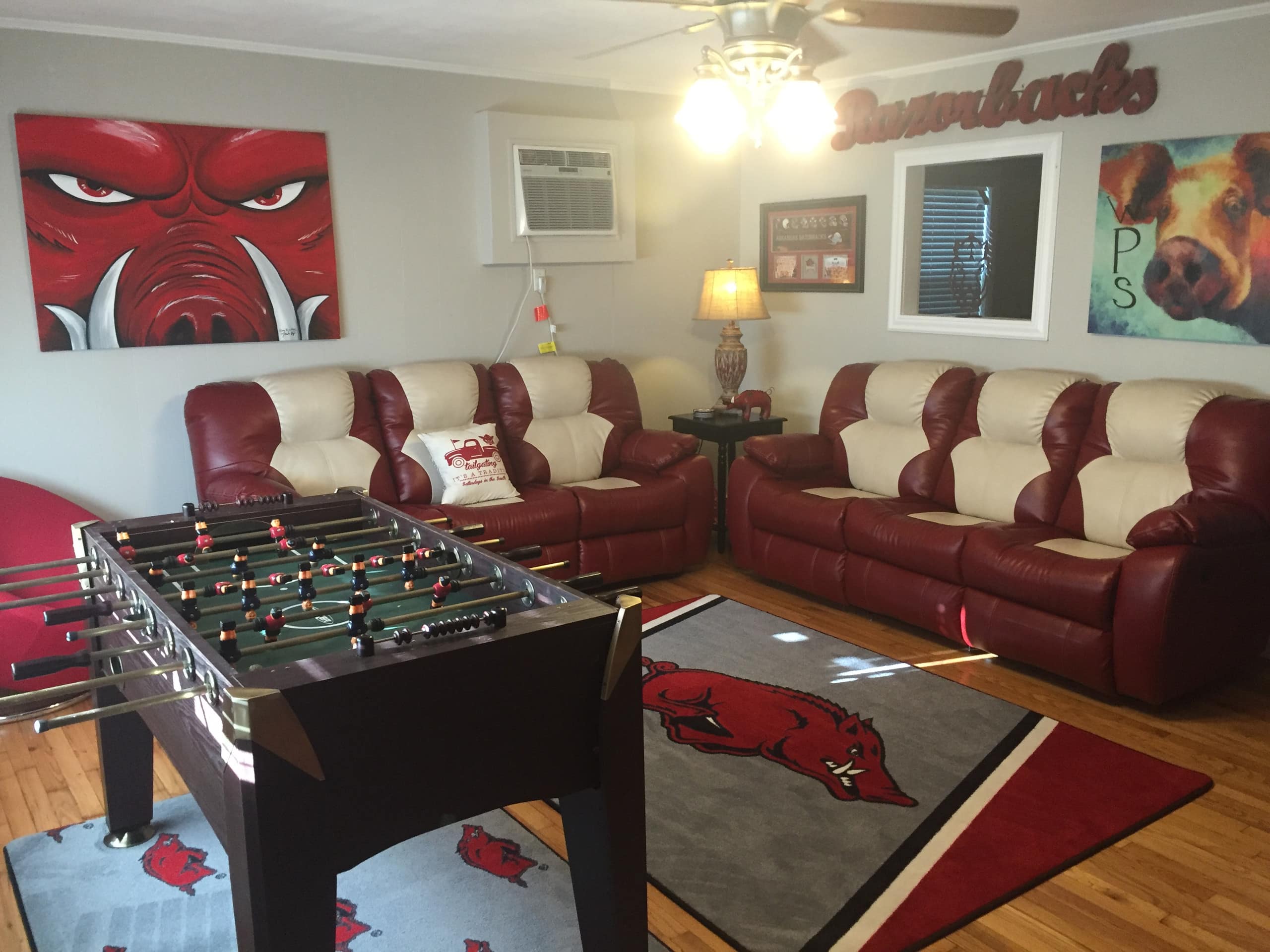 This Razorbacks-themed house has hog decorations and a foosball table in the living room.