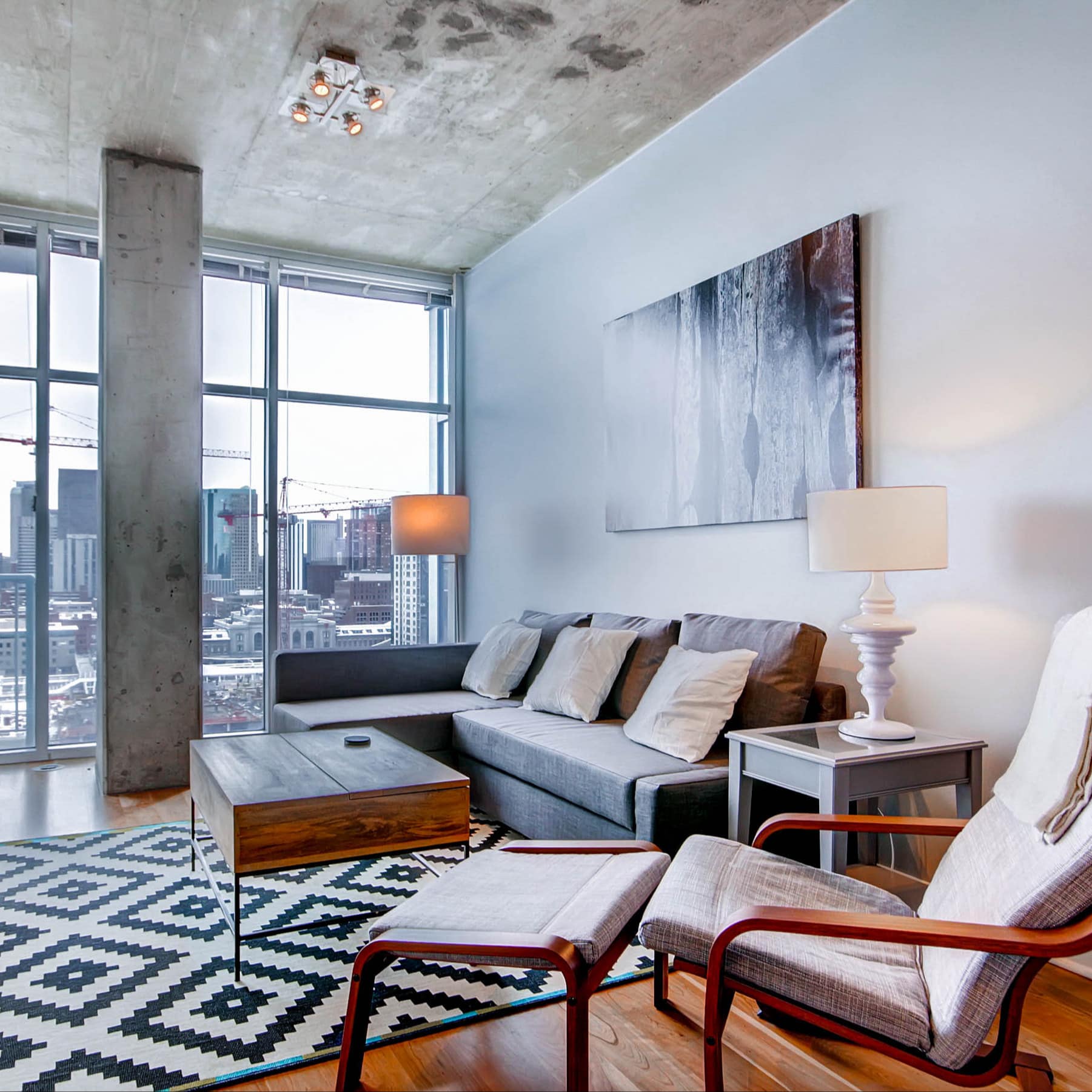 Highrise condo with skyline views and concrete interior in Downtown Denver