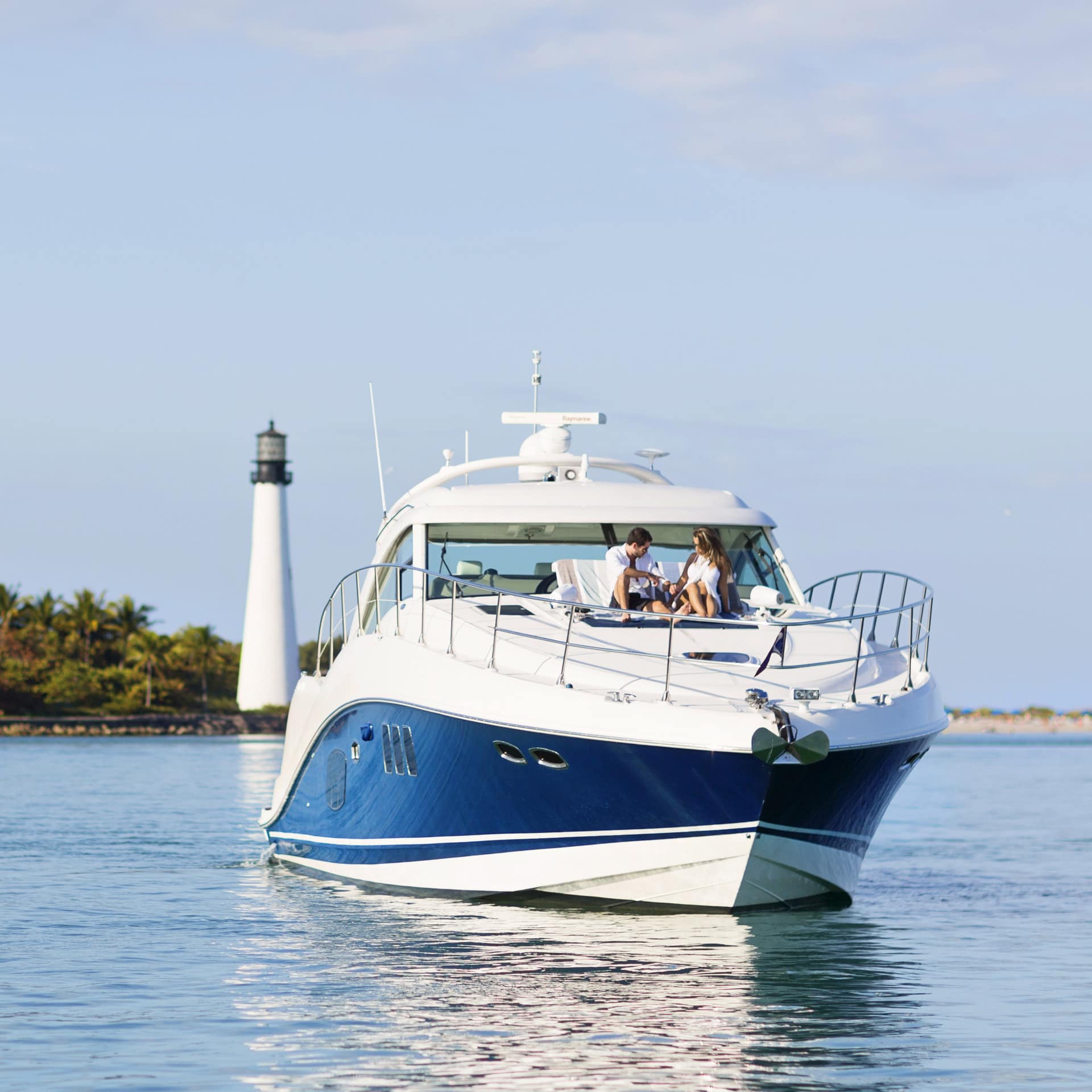 Two people relax on a luxury yacht near the coast of Miami