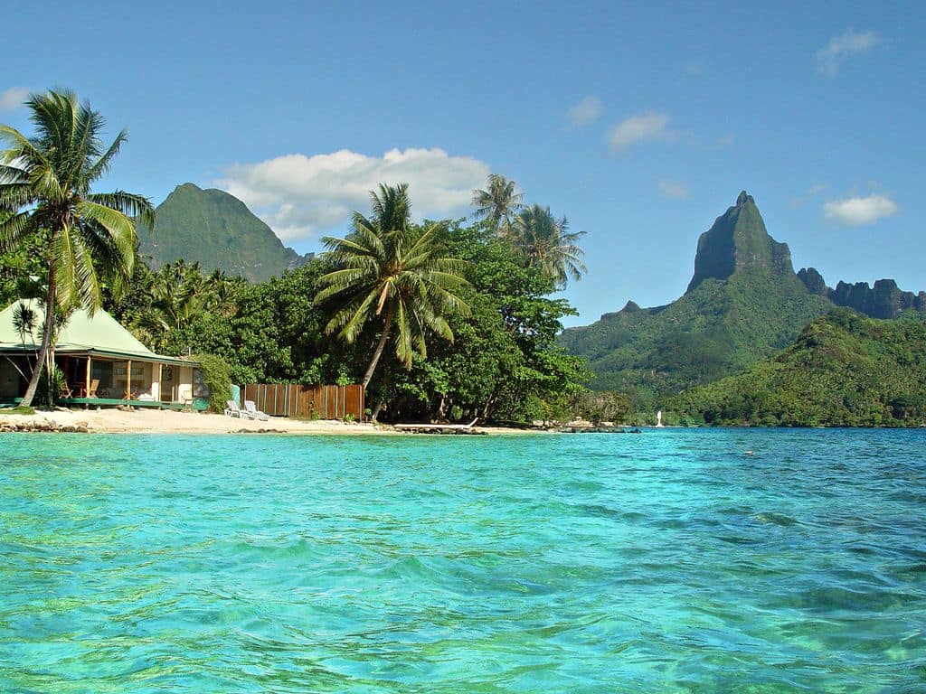 Villa surrounded by water and a lush tropical landscape similar to the planet of Scarif.