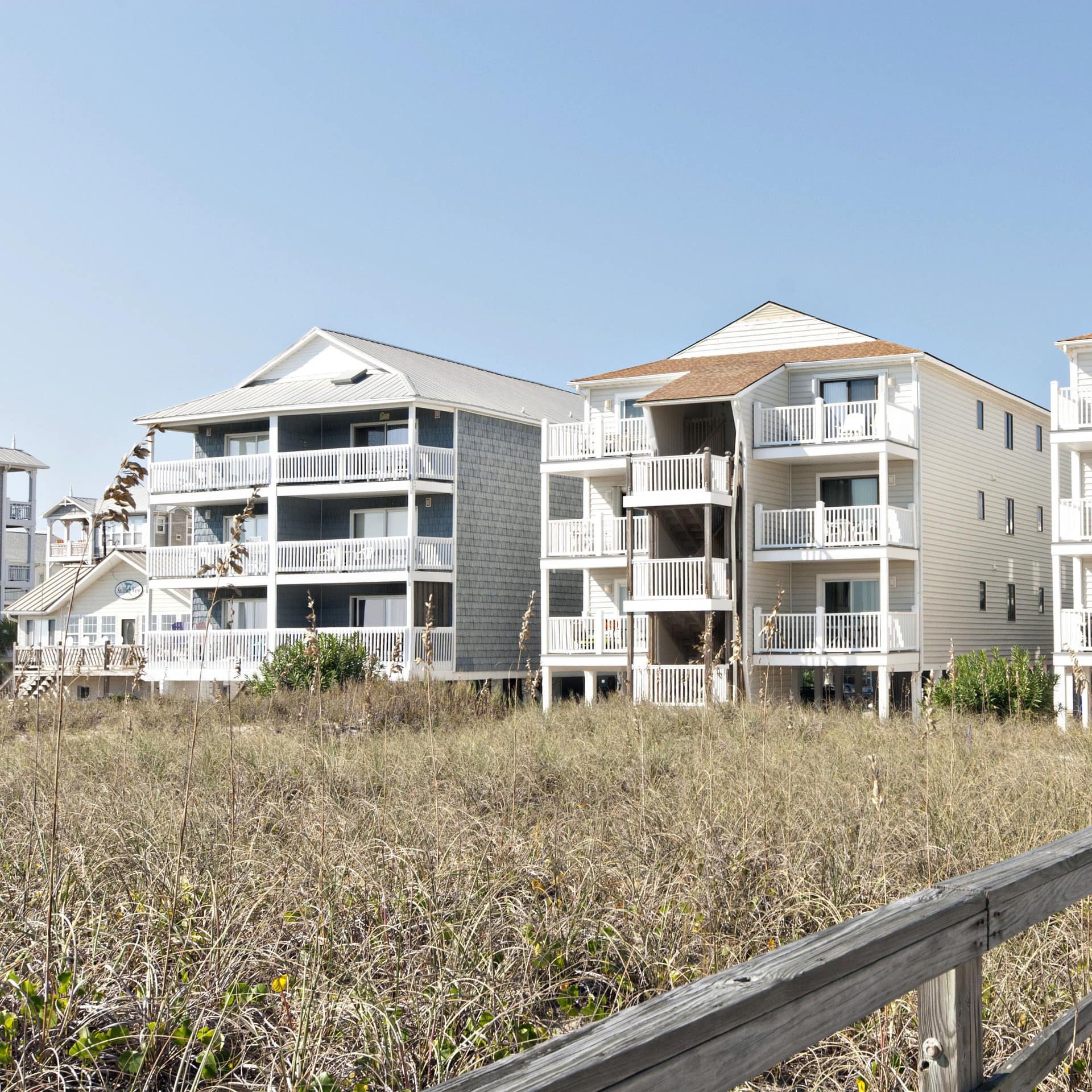 White low-rise condo blocks with balconies on Carolina Beach