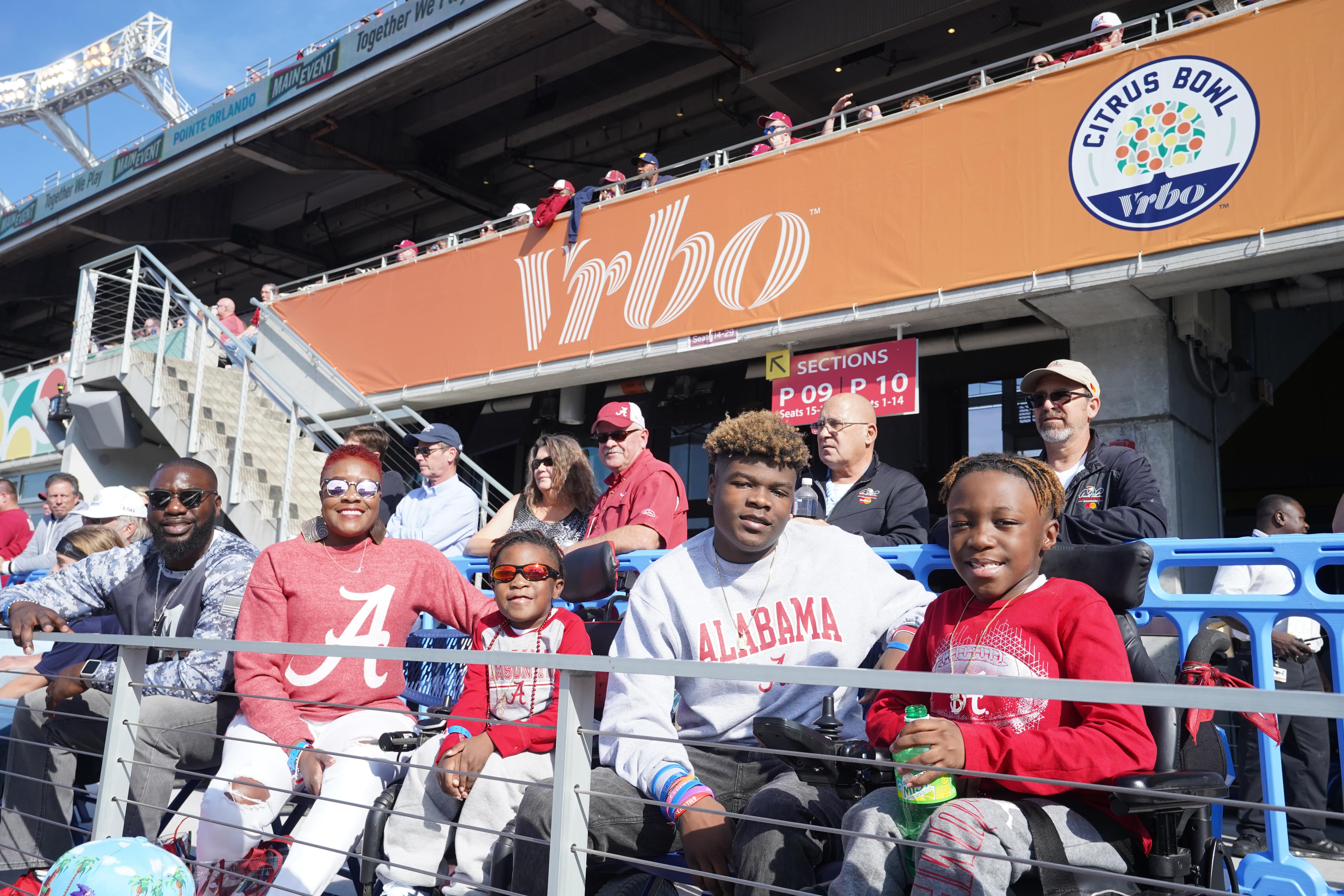 This is a photo of the Moore family at the 2020 Vrbo Citrus Bowl wearing University of Alabama shirts. 