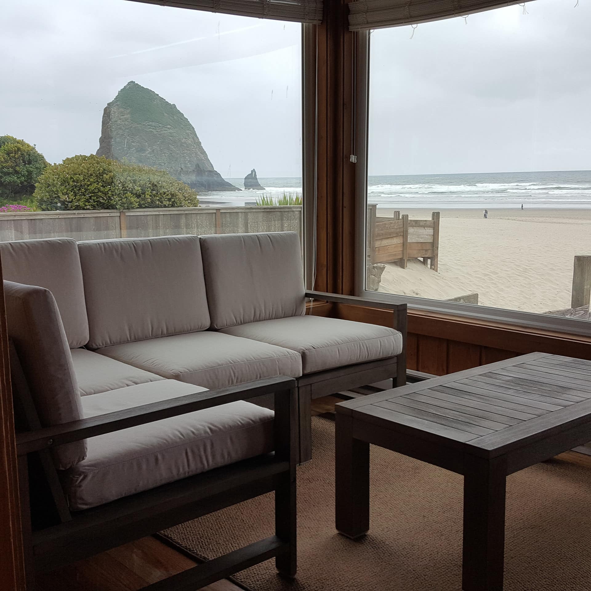 Living room with huge windows overlooking the beach and Haystack Rock.