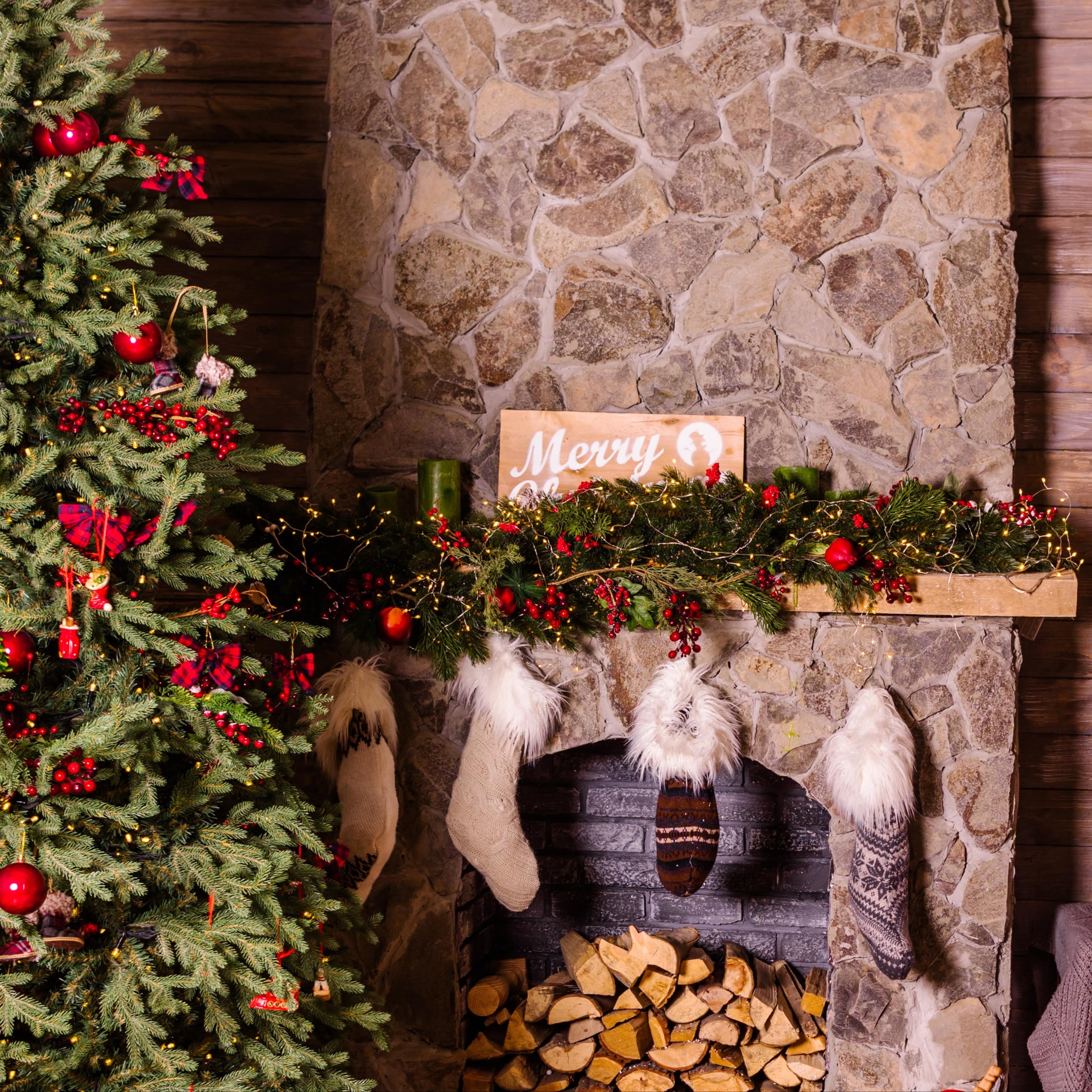 A festive fireplace and decorated tree in a vacation rental