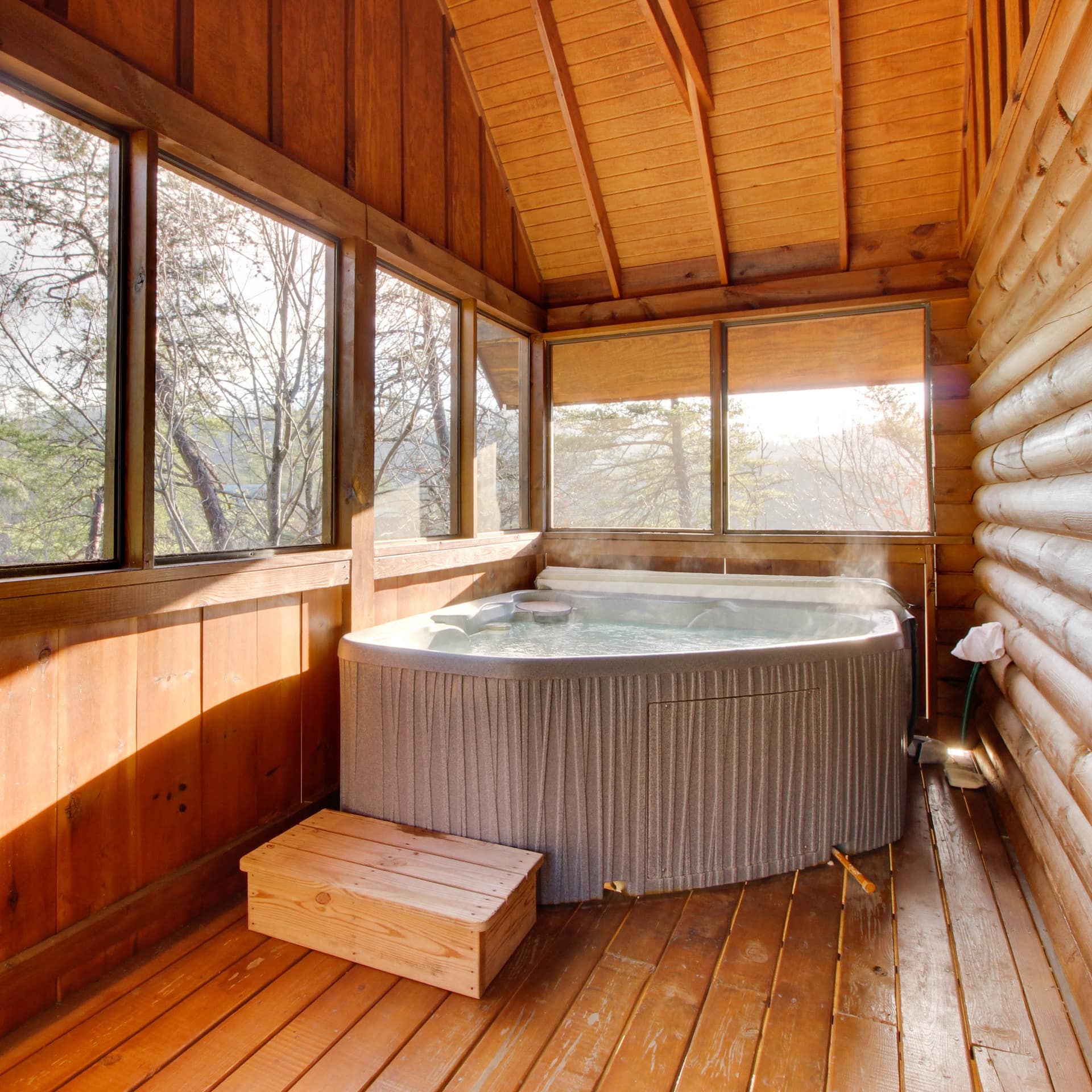Enjoy views of the wooded surroundings while submerged in the hot tub on this cheap Pigeon Forge cabin’s shaded deck.